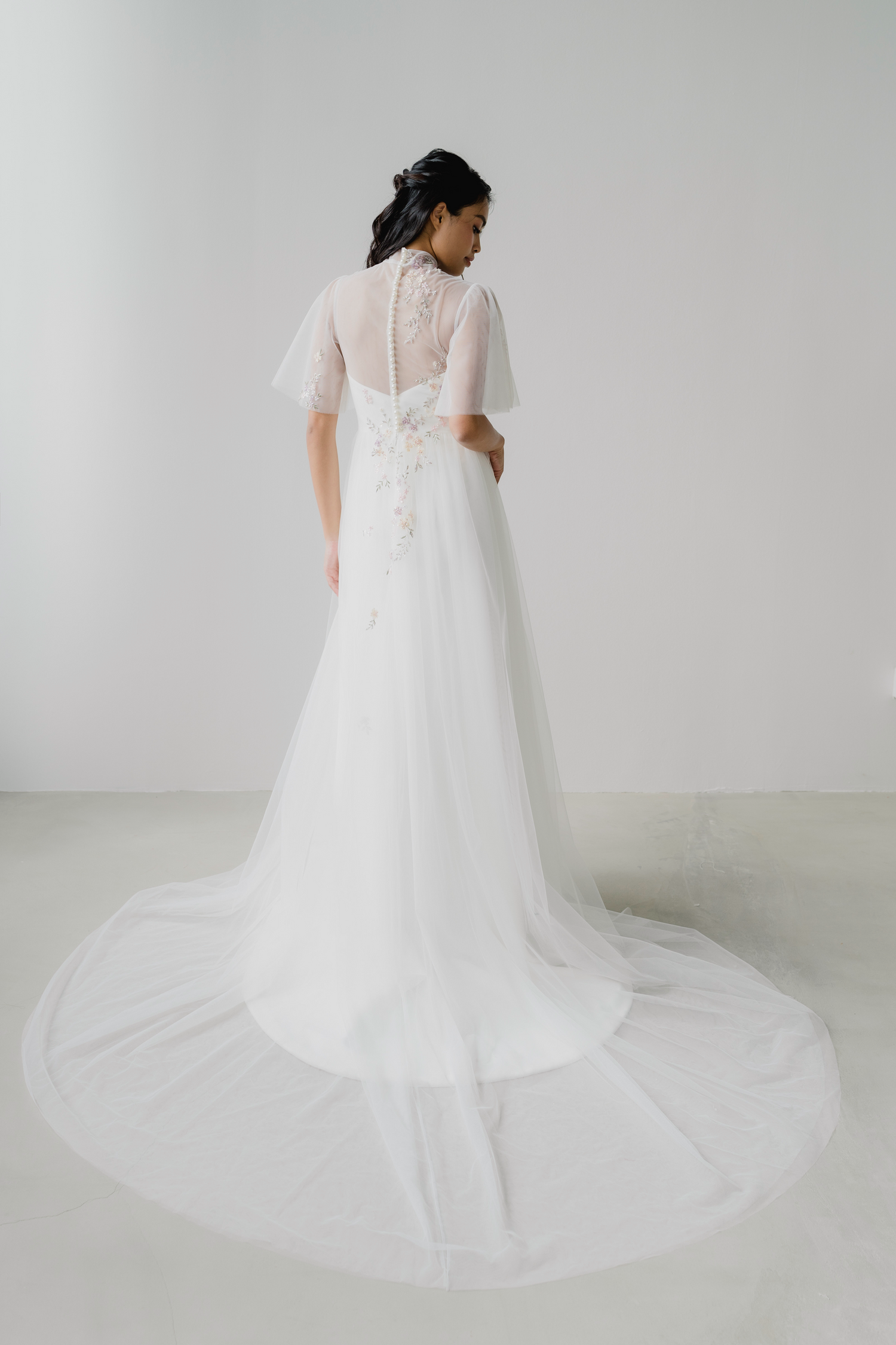 Angeline bridal cheongsam back view with delicate beaded floral detailing