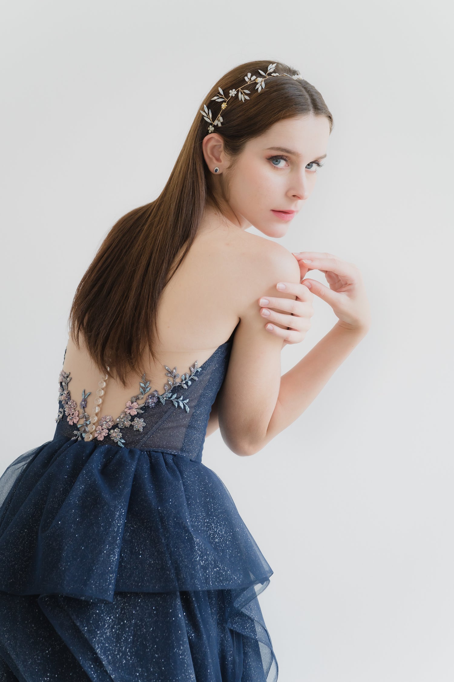 Brenda bridal evening gown side view with cascading ruffles and a flowing silhouette