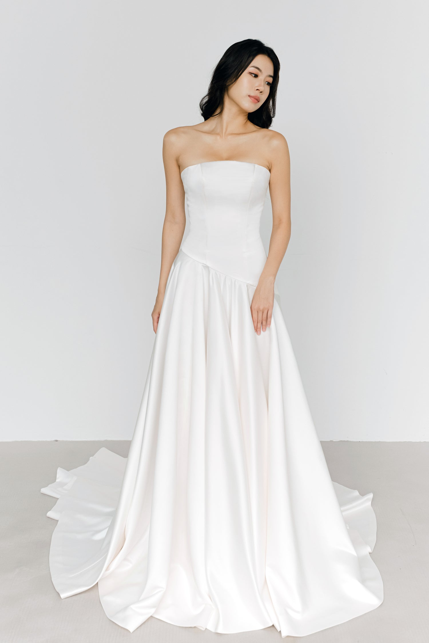 Carmen bridal gown featuring a modern asymmetrical drop waist