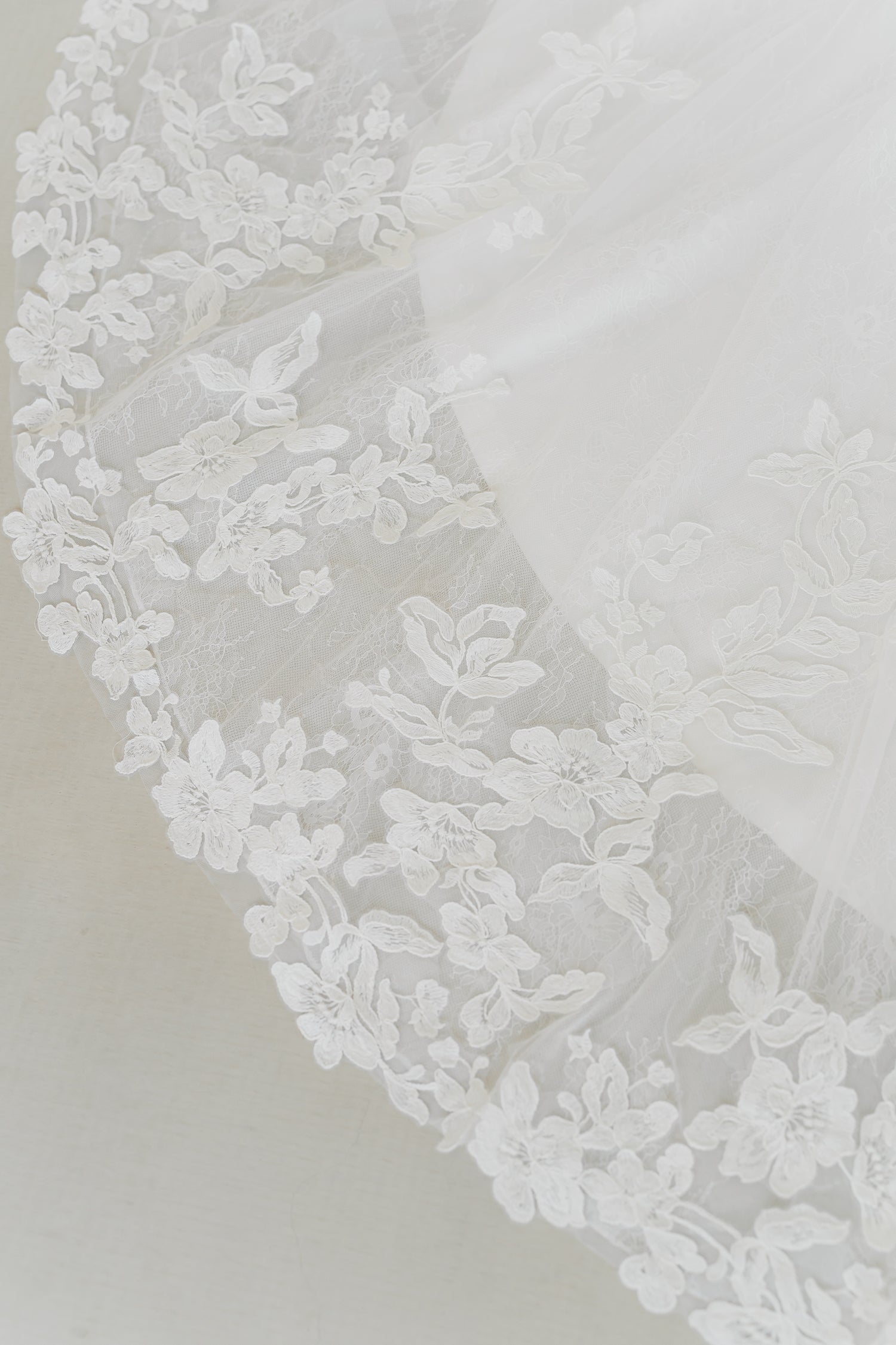 Close-up of Chevonne wedding gown highlighting the richly detailed full lace train