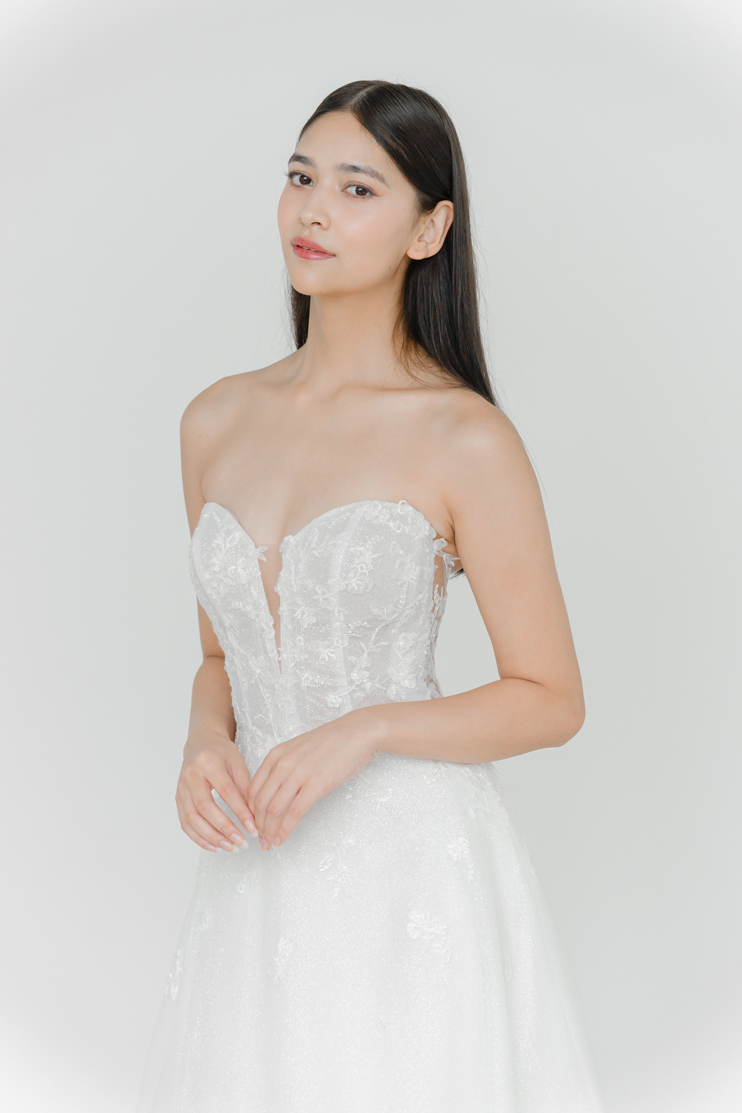 Cyra bridal gown featuring sparkling lace appliqués and a shimmering A-line skirt