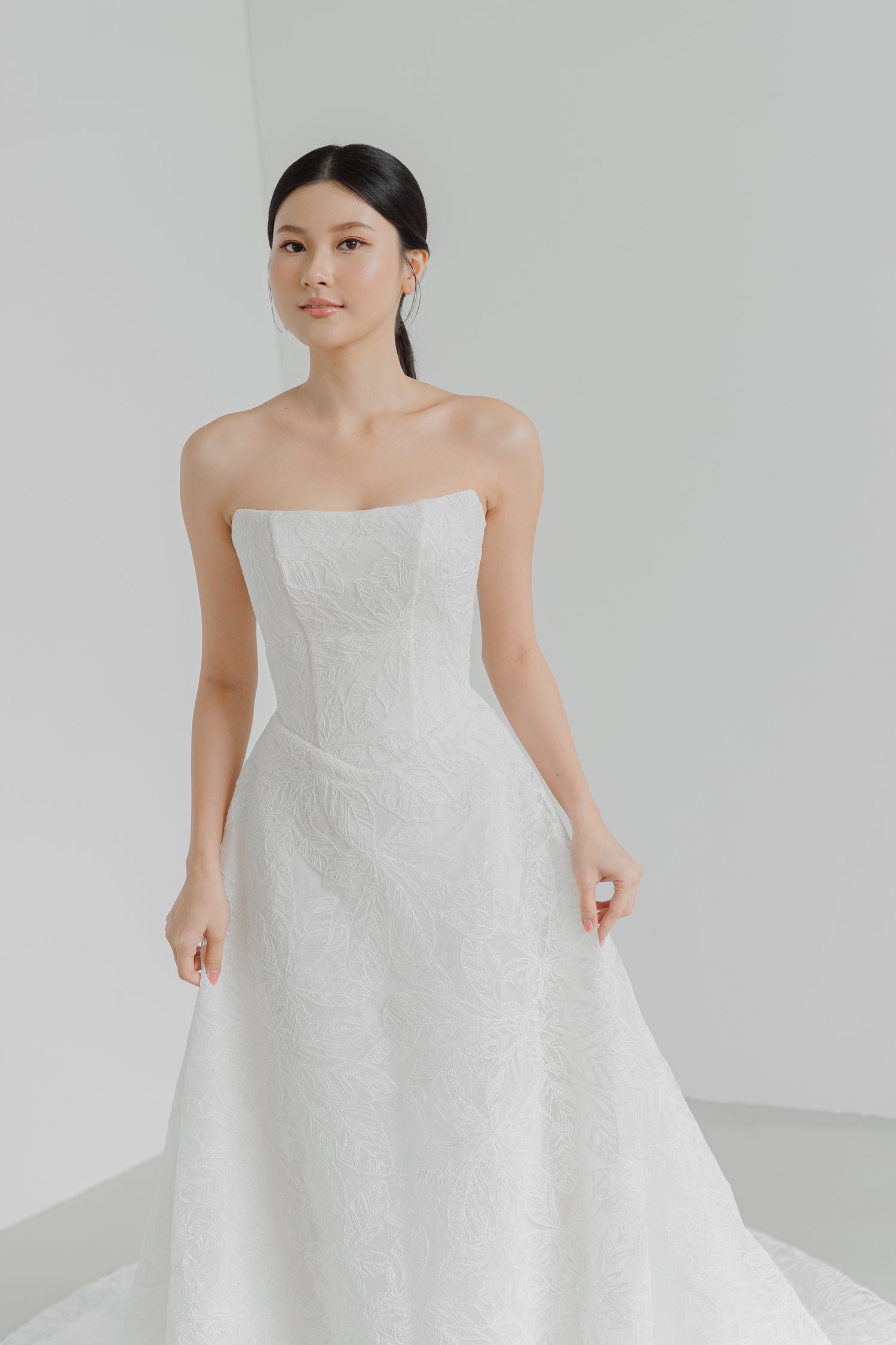 Dakota bridal gown featuring subtle leafy lace motifs and a minimalist silhouette