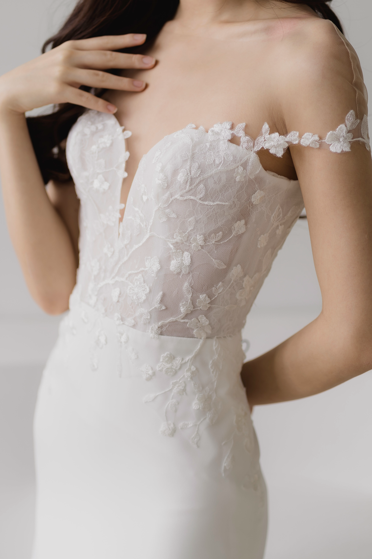 Close-up of Glenna wedding dress featuring the illusion off-shoulder neckline