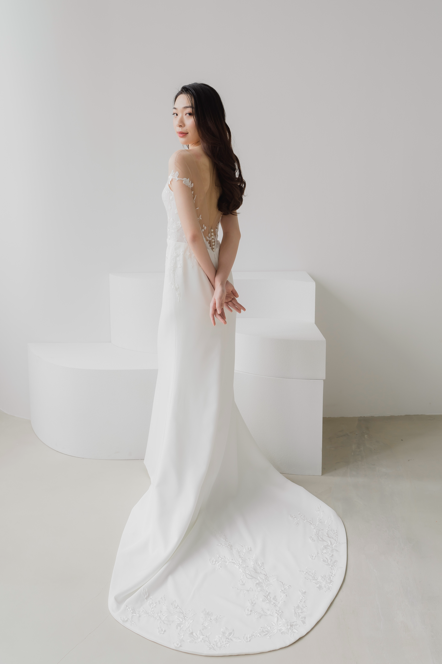 Glenna wedding dress side view with a fitted crepe silhouette