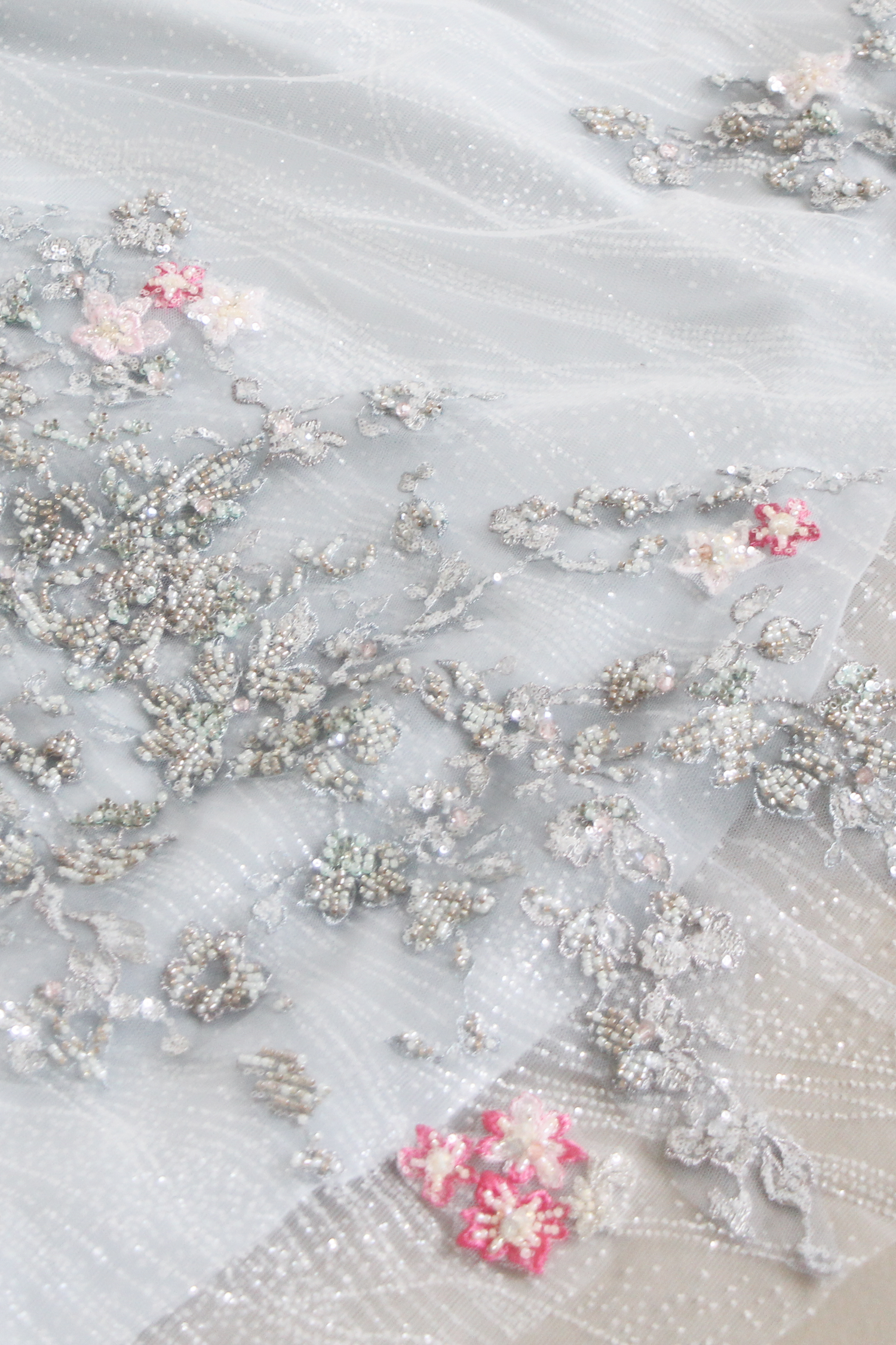 Close-up of Kaira bridal cheongsam highlighting the shimmering light blue glitter tulle