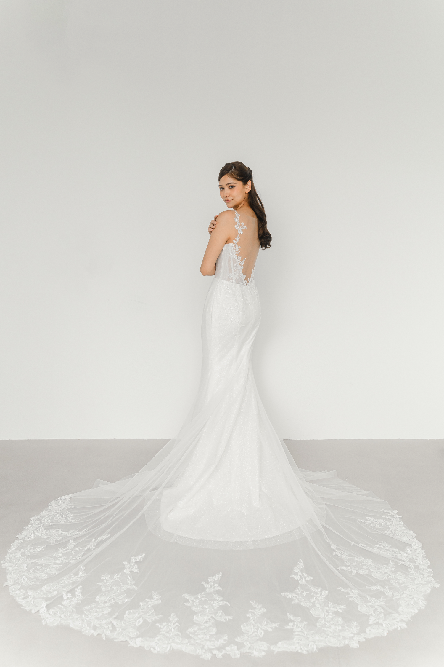 Kinsley bridal gown side view with a graceful fitted mermaid silhouette