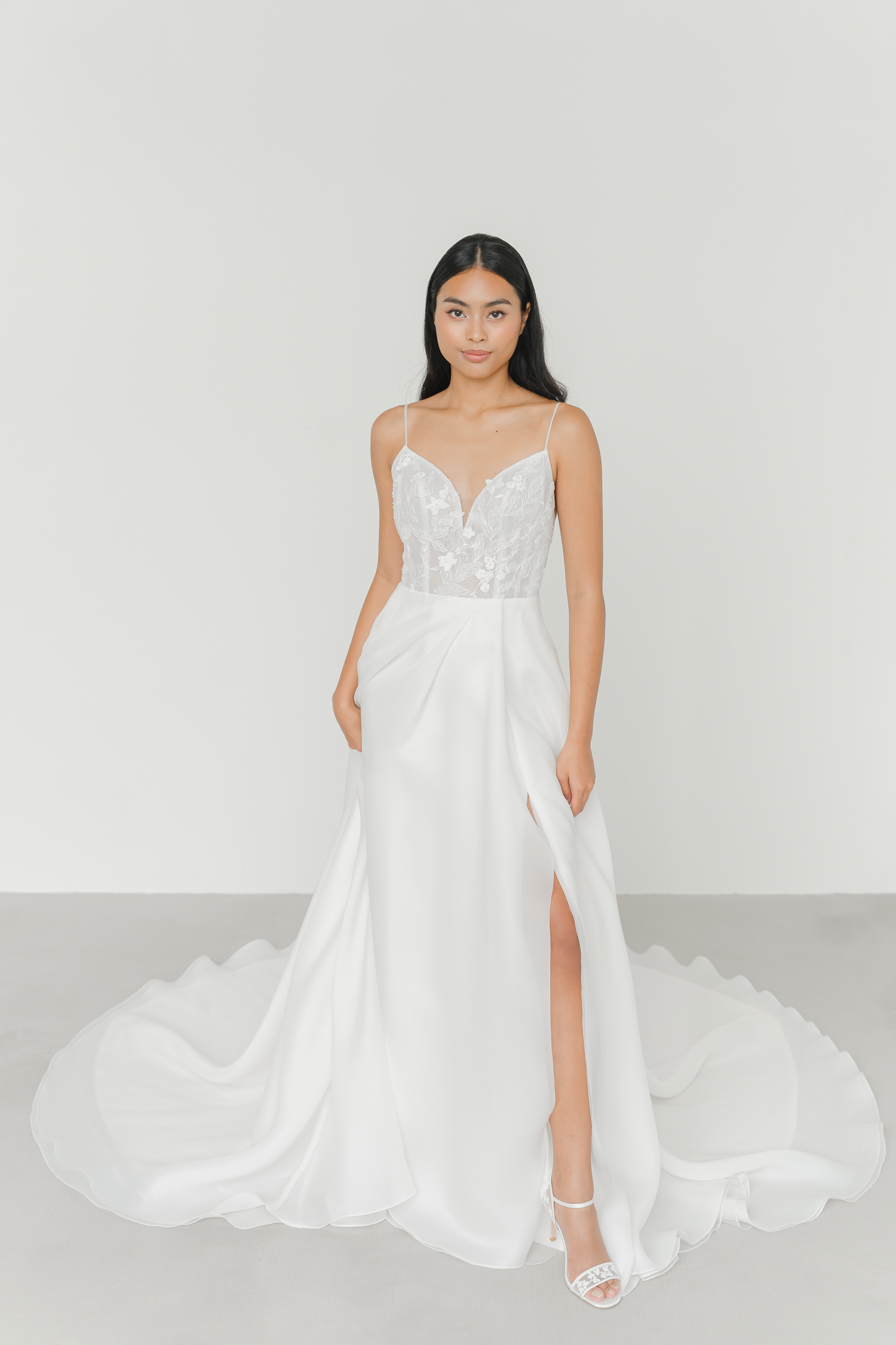 Layla wedding gown side view with a romantic organza A-line silhouette and thigh-high slit