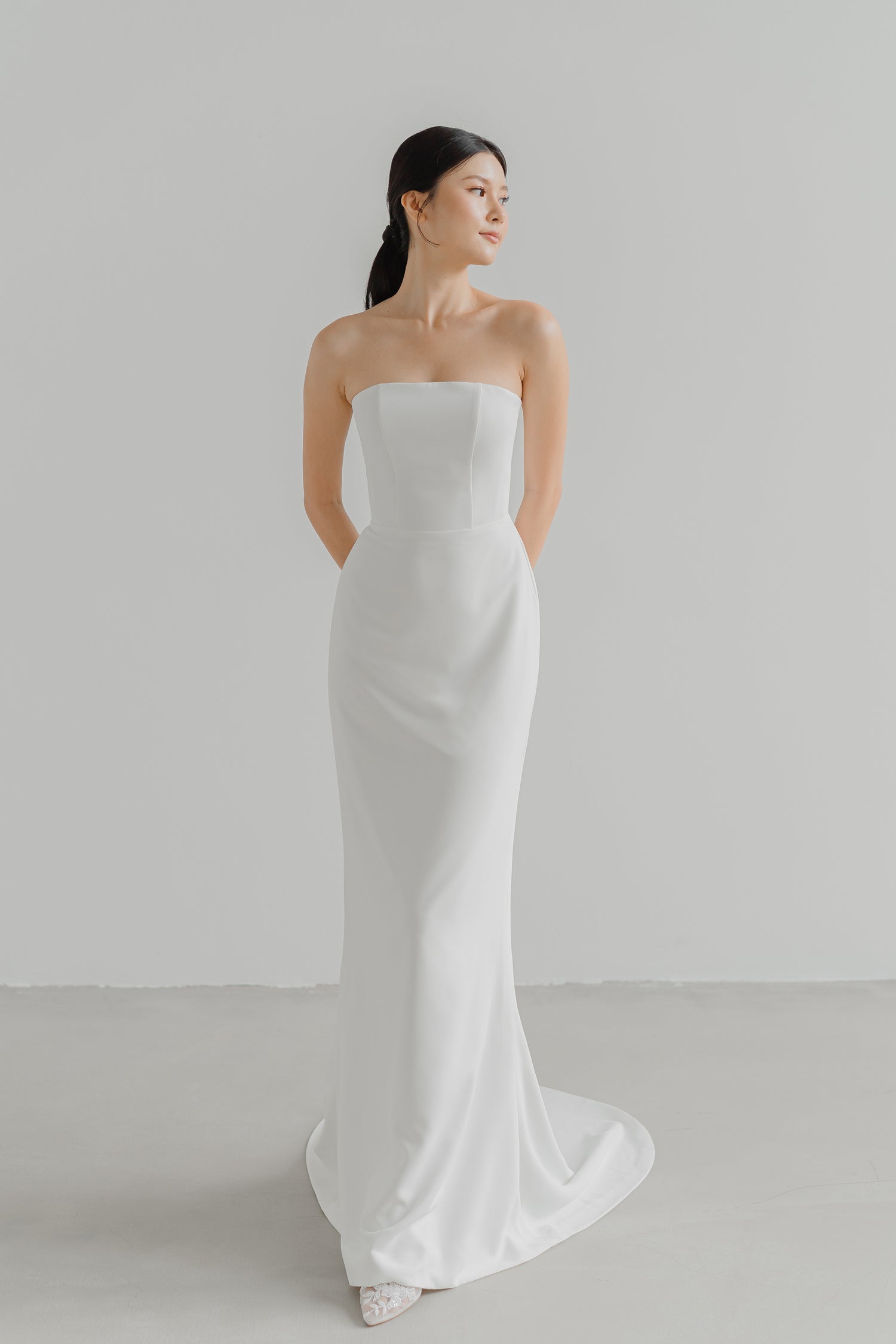 Lilith wedding dress front view with a sleek fitted silhouette