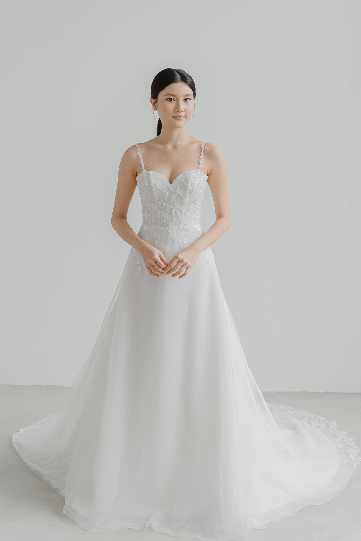 Lyra bridal gown front view with a timeless figure-flattering silhouette