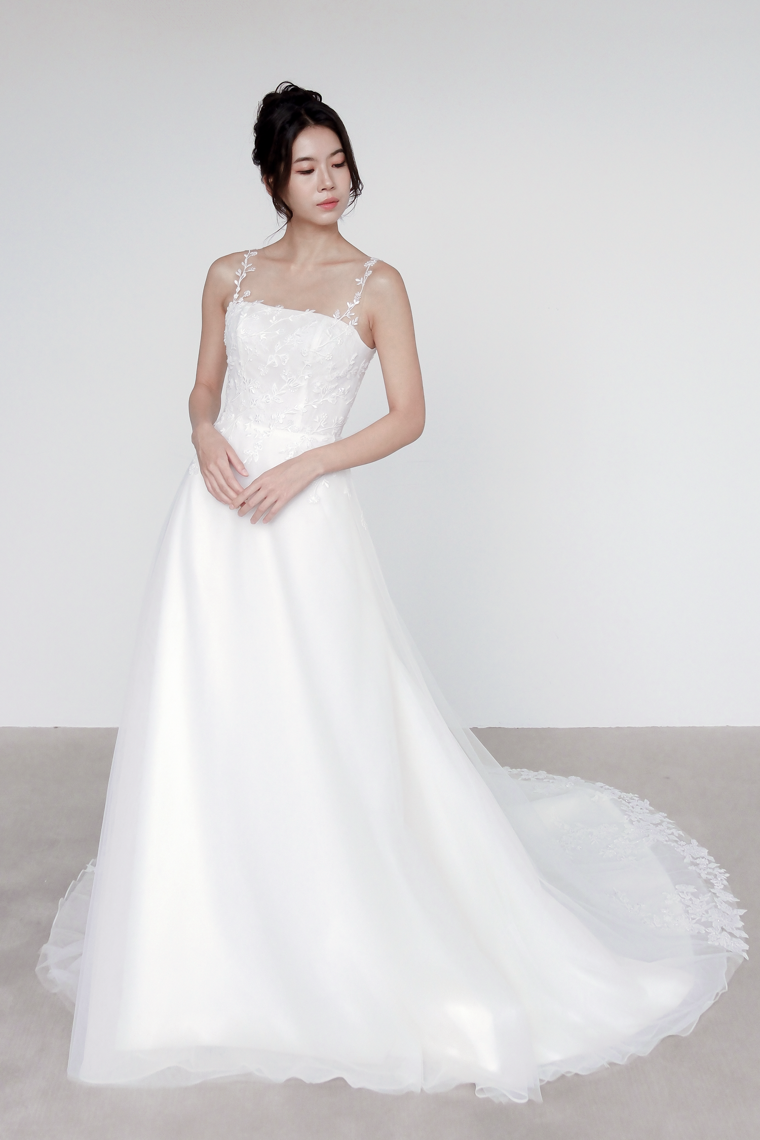 Meara bridal gown featuring delicate floral lace straps and a soft tulle skirt