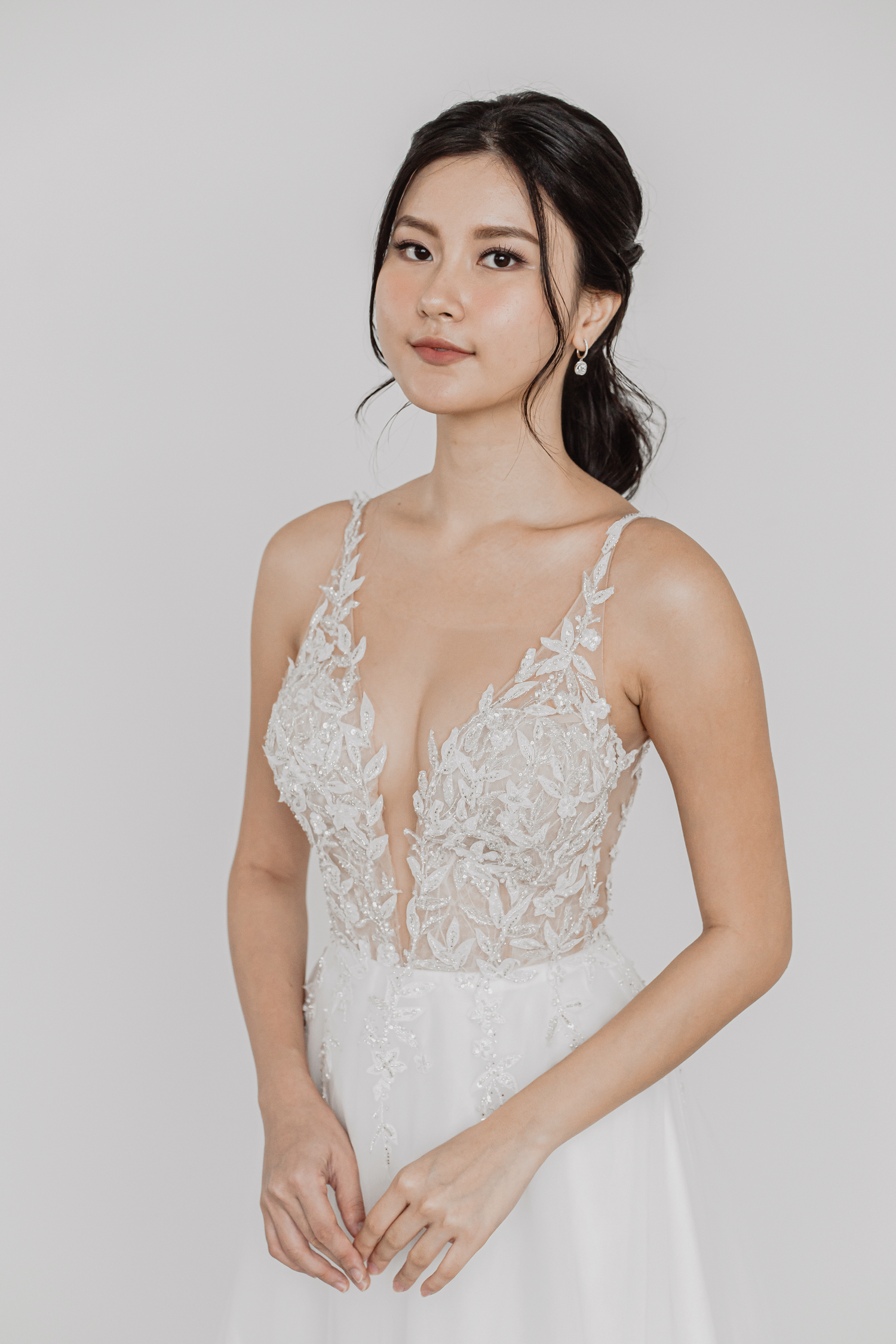 Mindy wedding dress front view with a plunging neckline and illusion bodice
