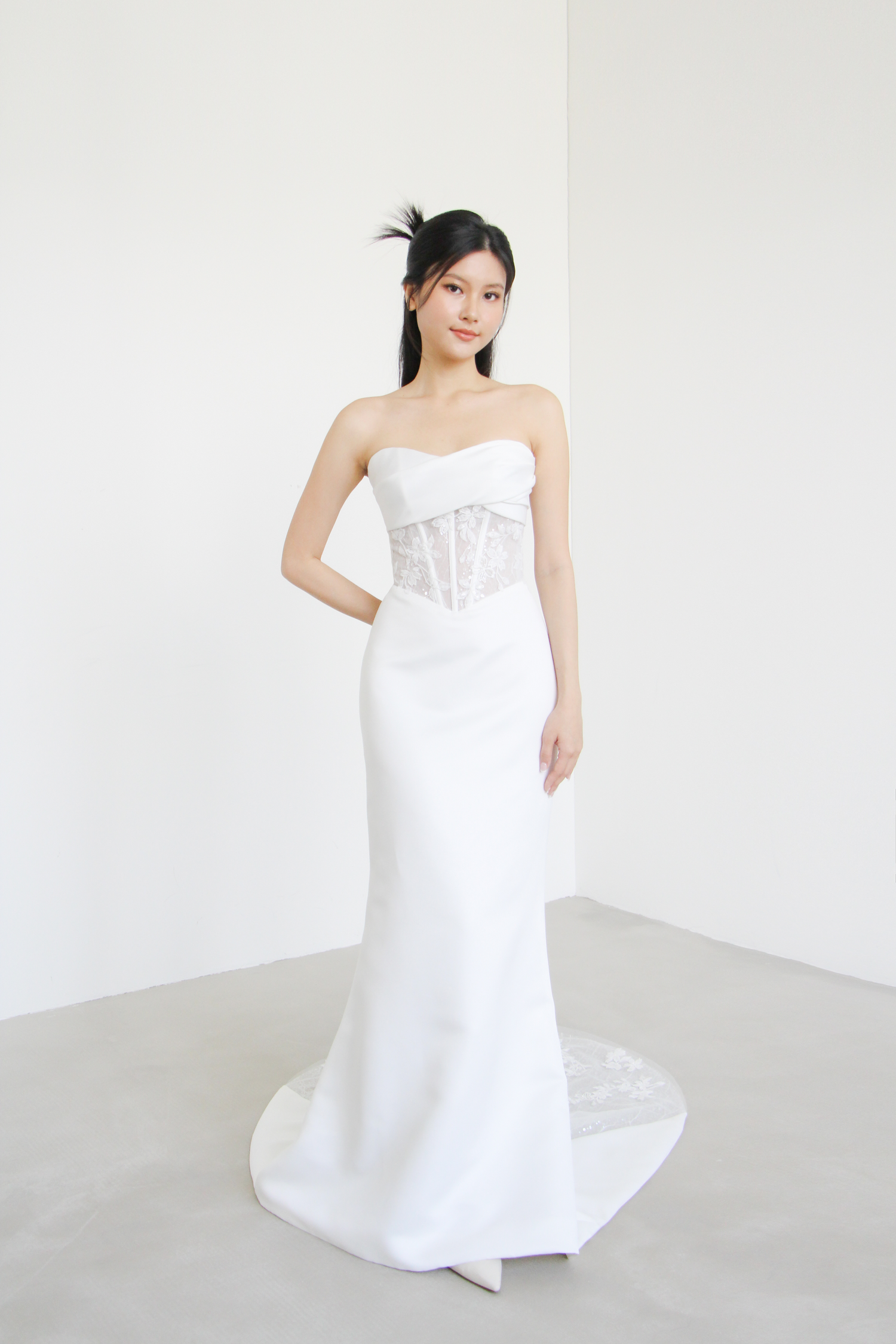 Nayara wedding dress front view with a twisted sweetheart neckline and structured corset bodice