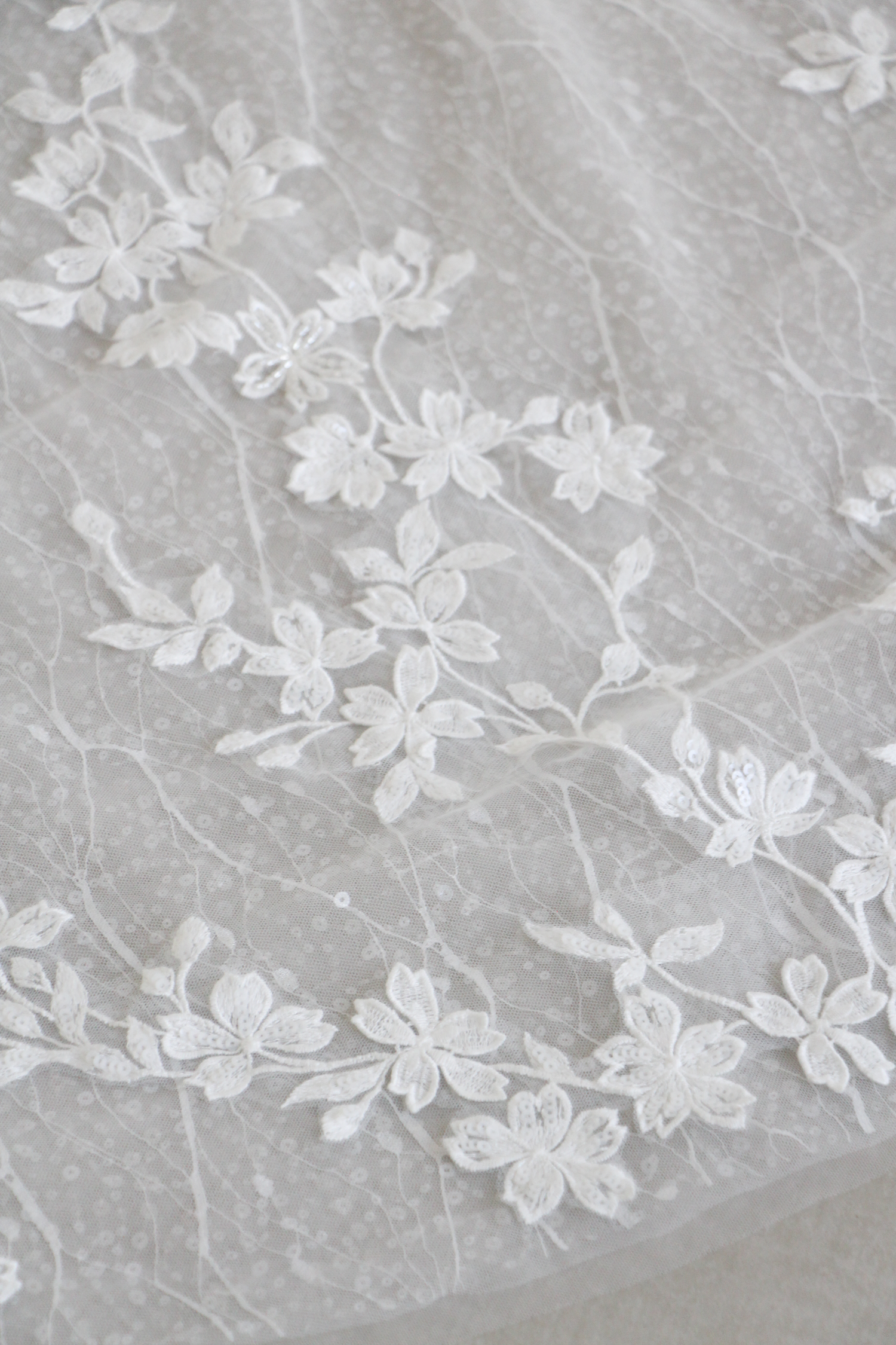 Close-up of Nayara wedding gown highlighting the peekaboo lace train and intricate lace detailing
