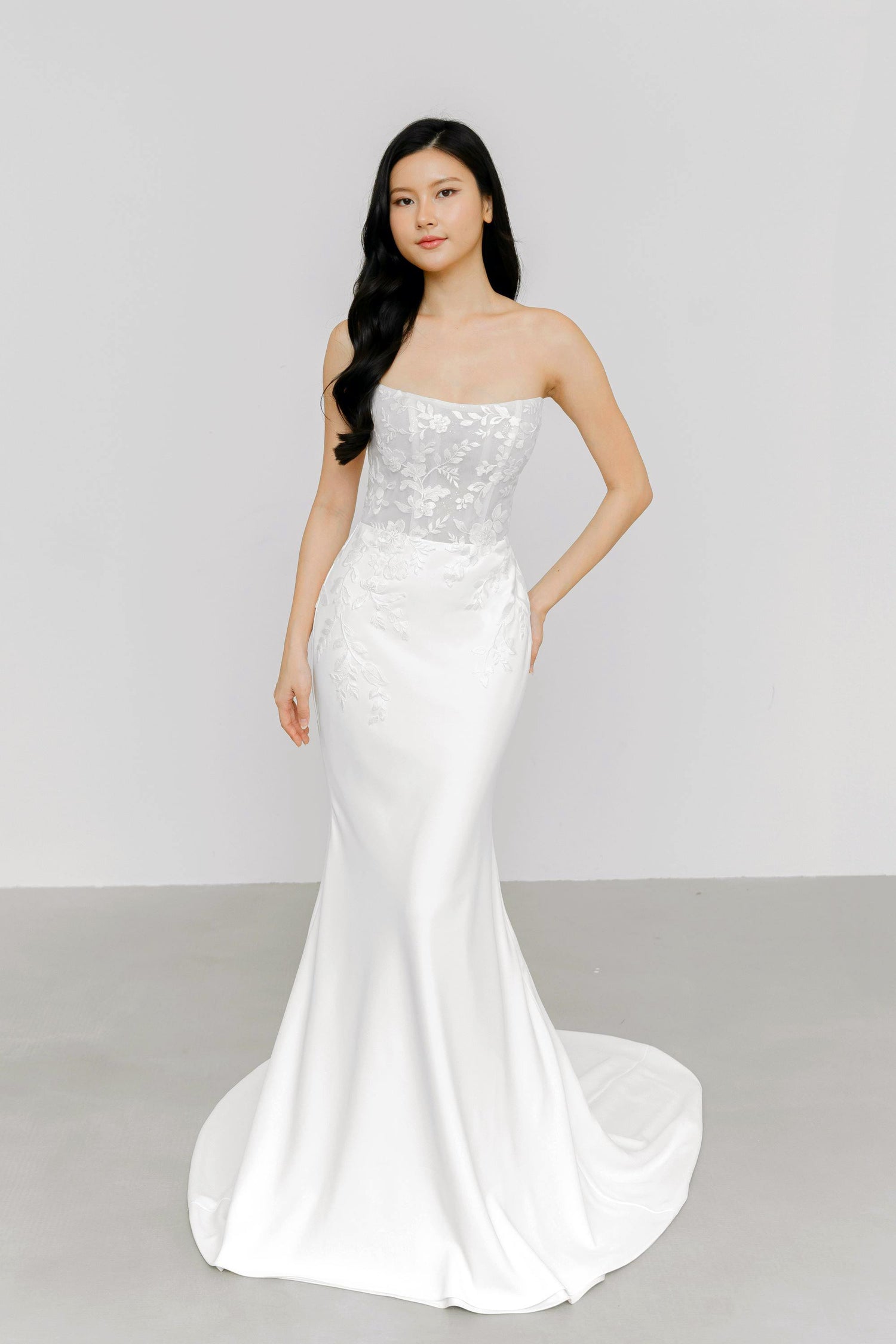 Nerissa wedding dress front view with a lace bodice and relaxed mermaid silhouette