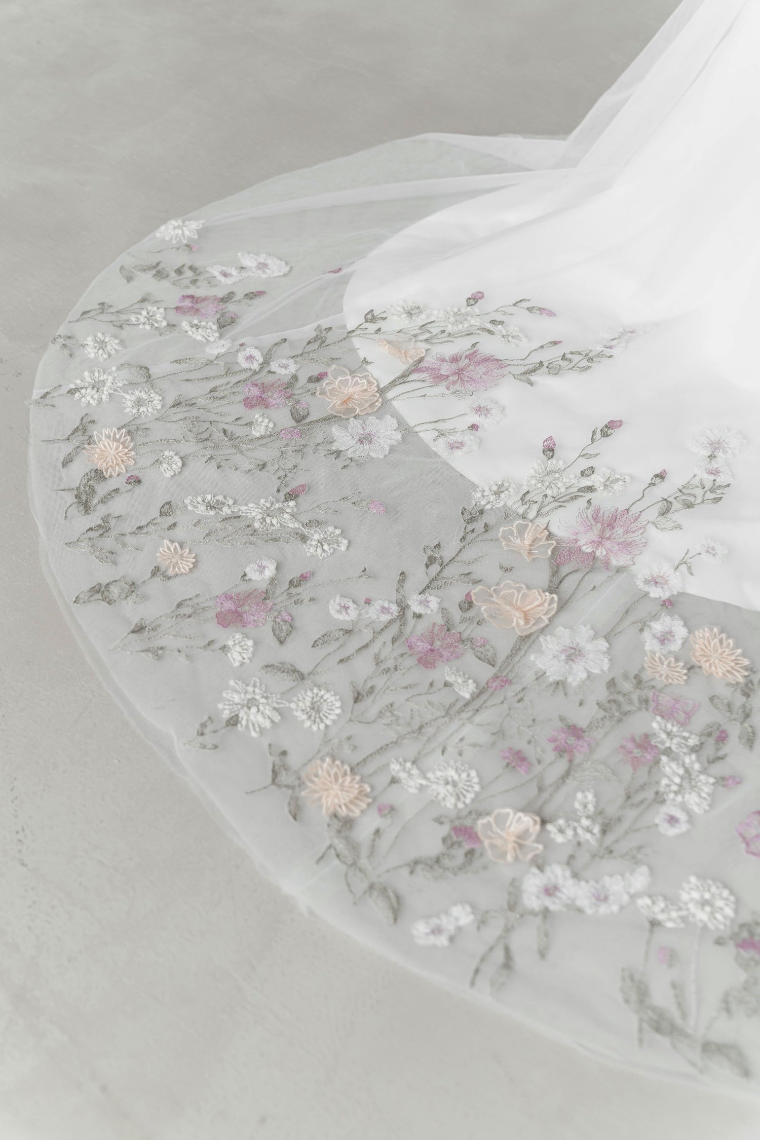 Close-up of Penny wedding cheongsam highlighting the delicate pastel lace
