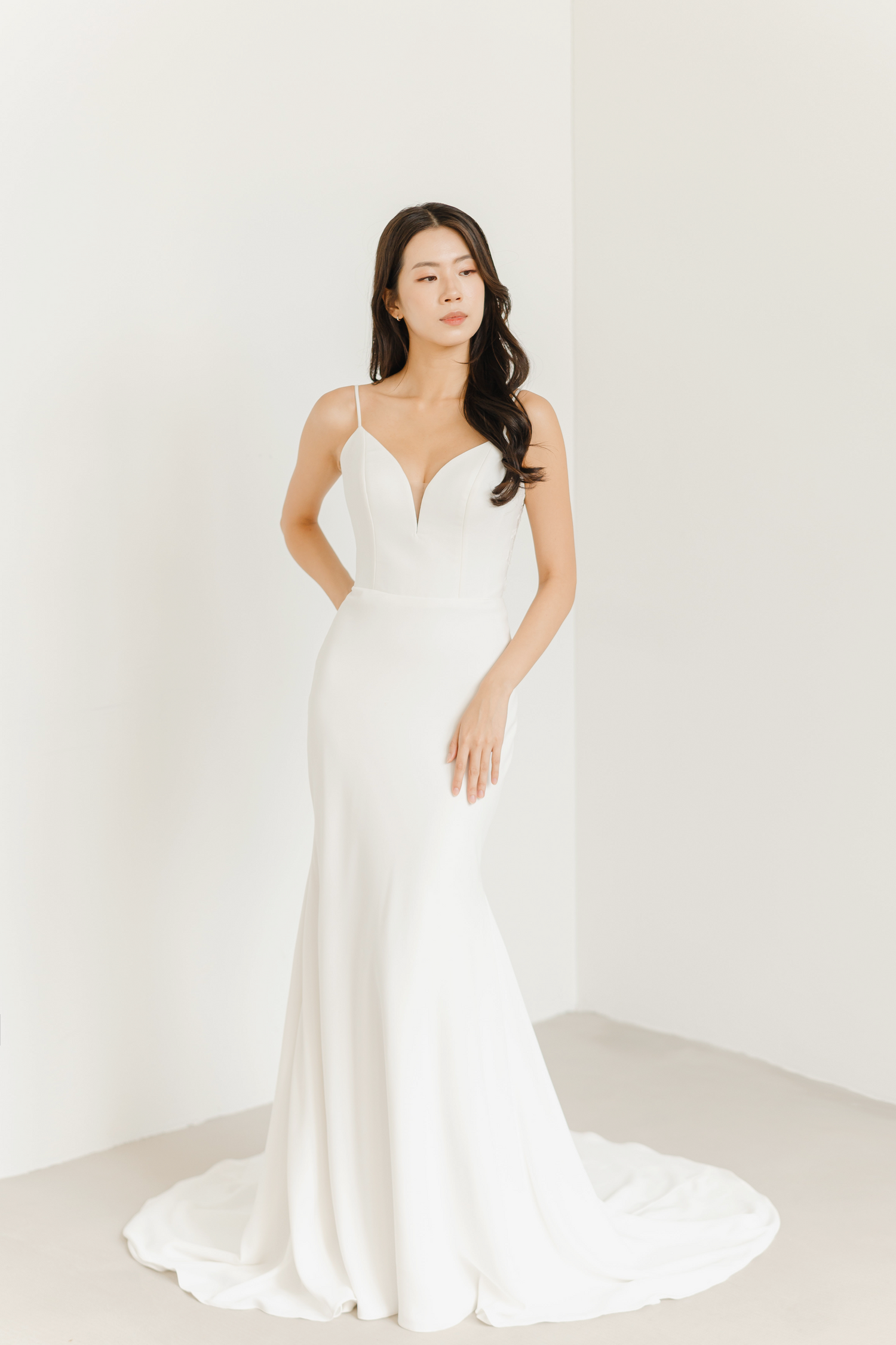 Raina bridal gown featuring slender spaghetti straps and a minimalist design