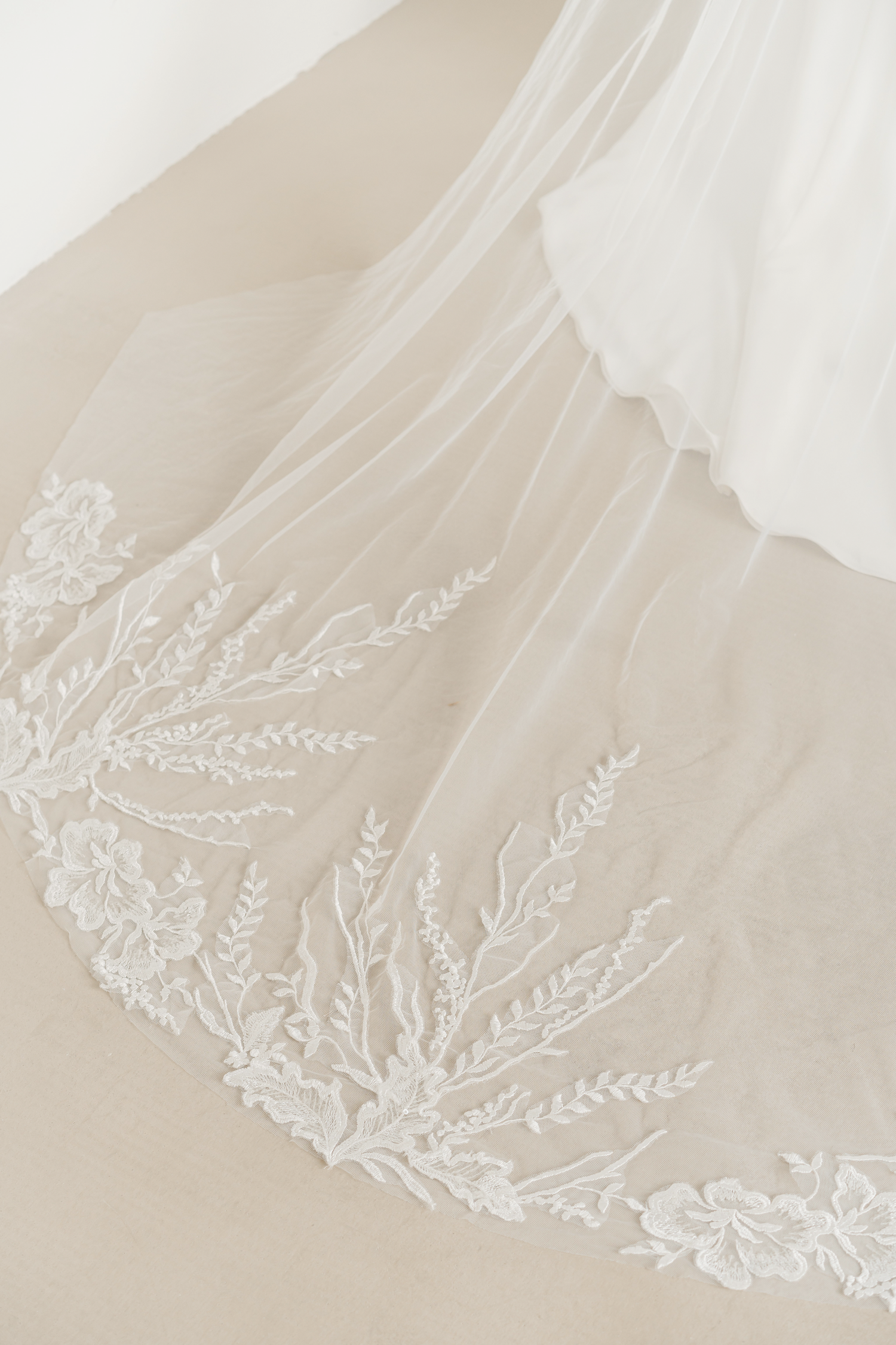 Raina wedding gown train showcasing delicate lace detailing and an elegant flowing train