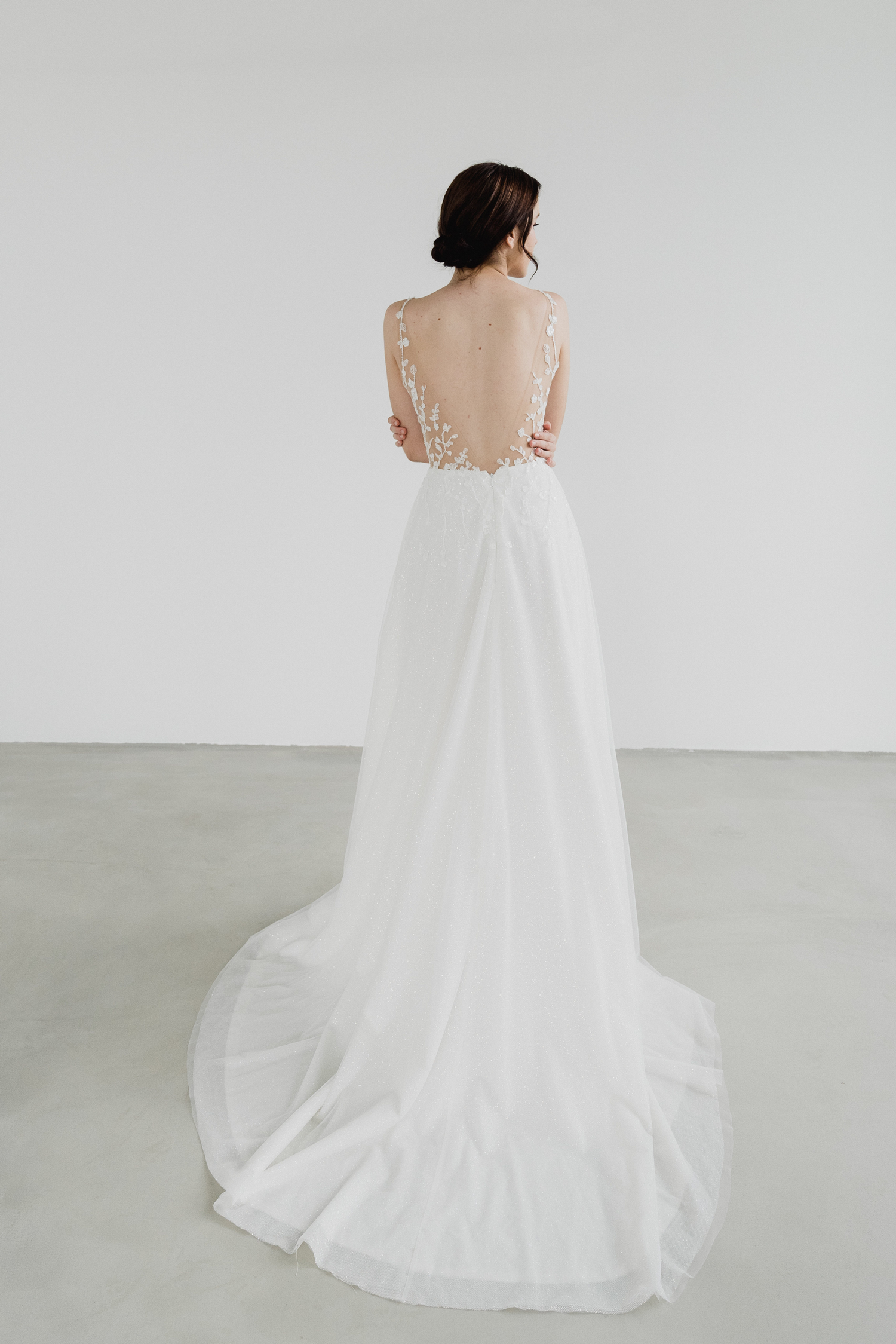 Reimi bridal gown back view with a low V-back without the cape