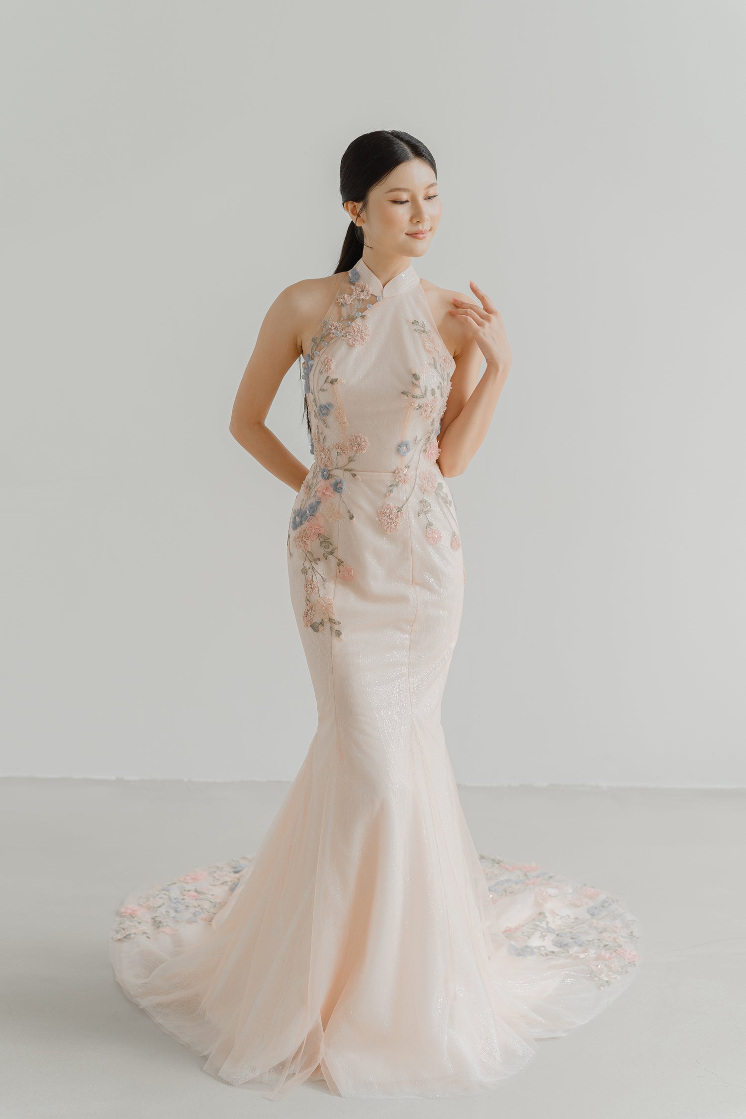 Rowan wedding cheongsam front view in a soft blush hue with pastel floral lace