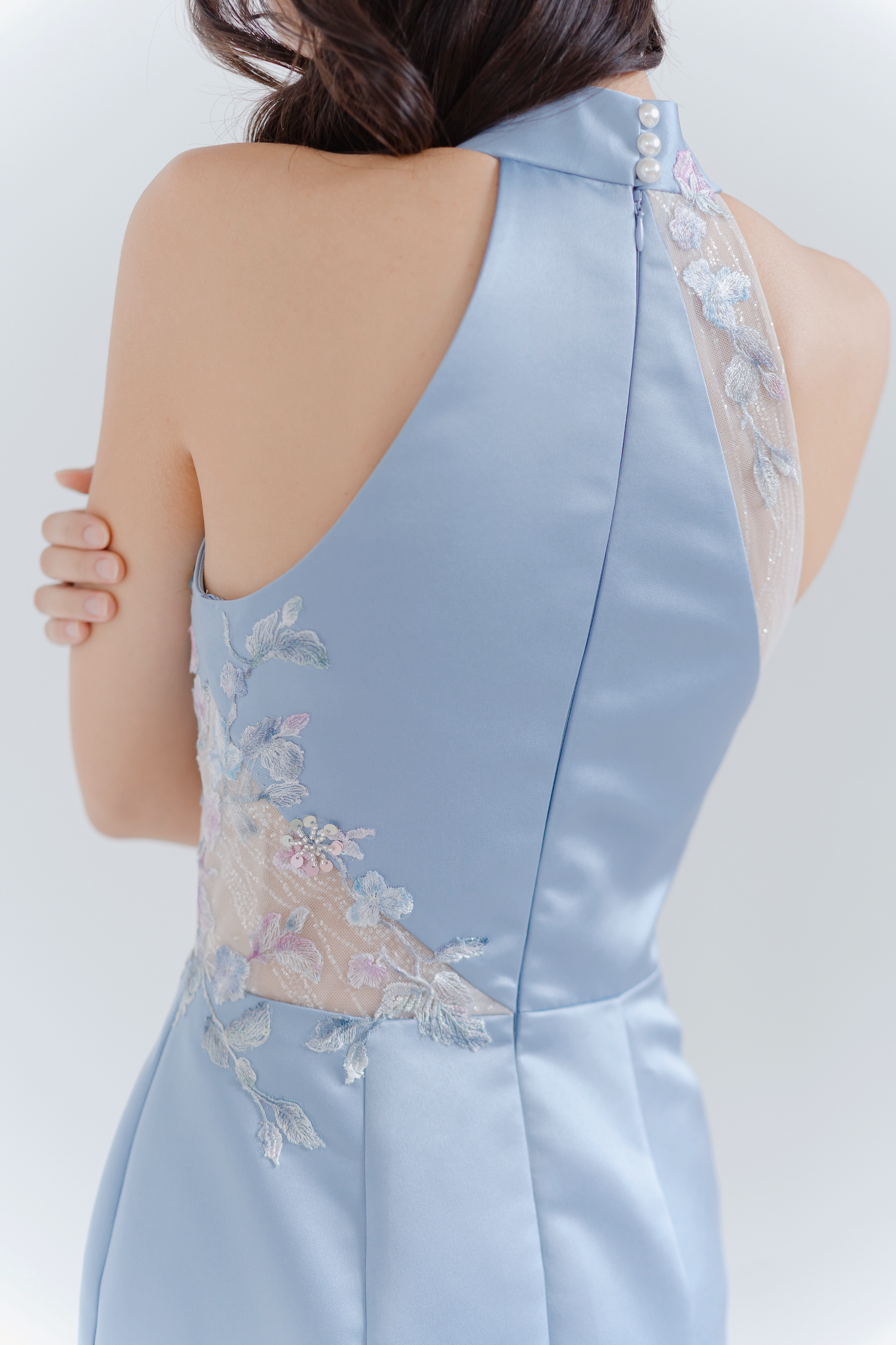 Close-up of Ryo bridal cheongsam showcasing the delicate lace and glitter panel detailing