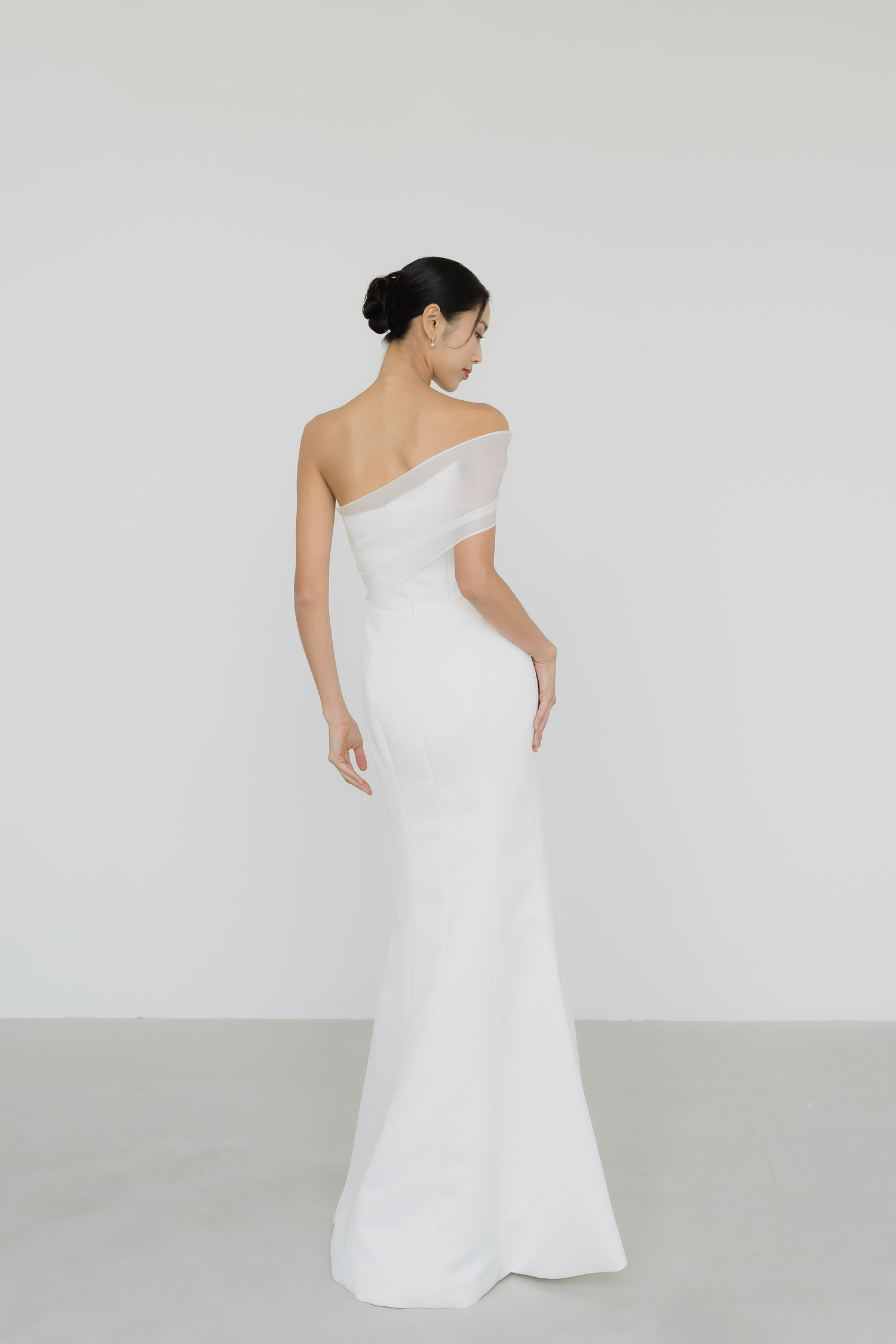 Close-up of Sabrina bridal gown showcasing the one-shoulder organza wrap