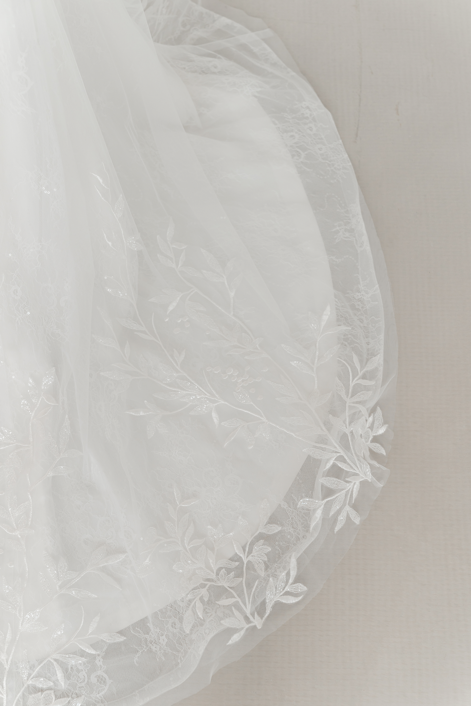 Sally wedding gown train showcasing sequinned leafy lace and an elegant flowing train