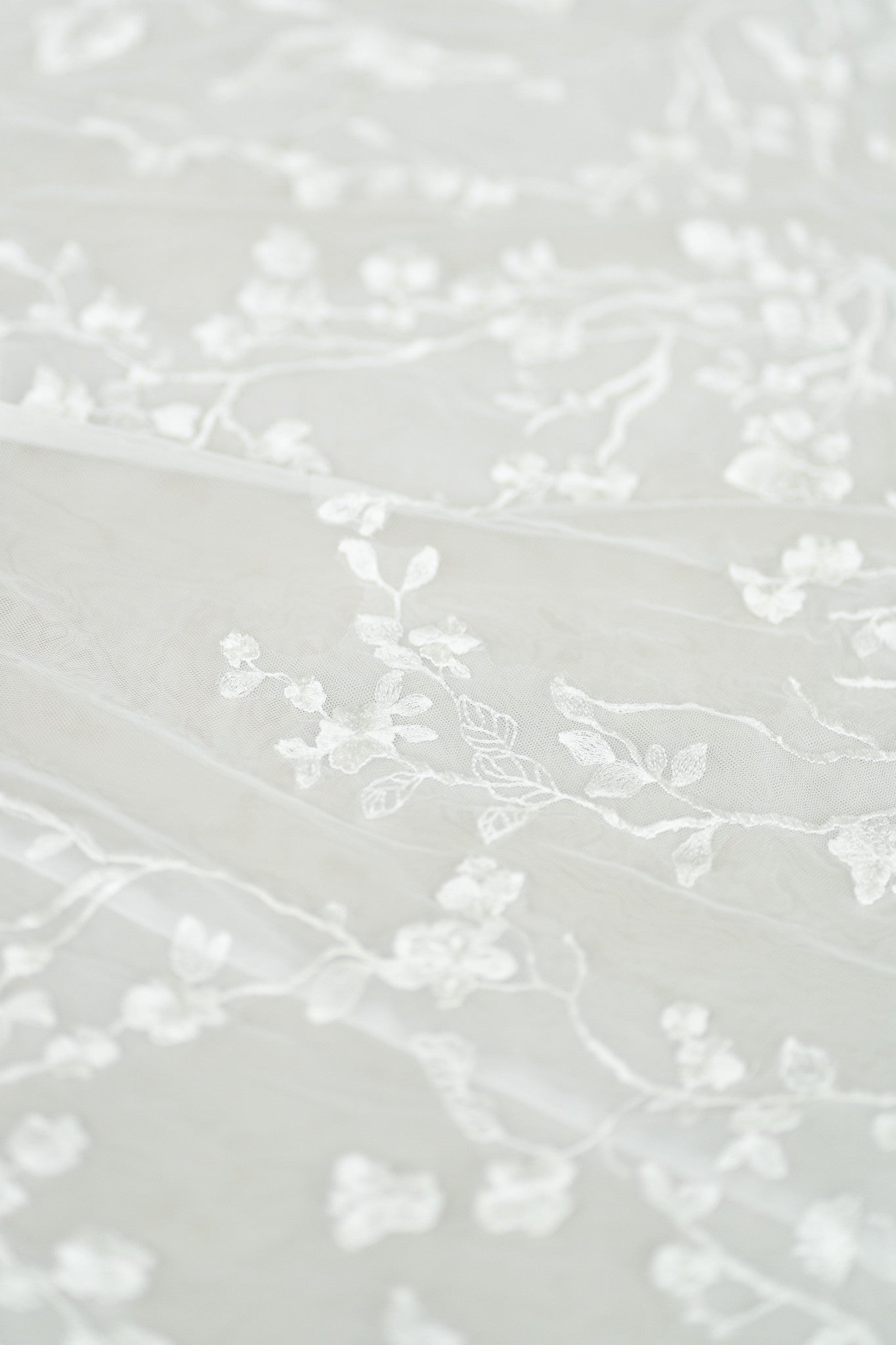 Close-up of Sarah wedding cheongsam lace and tulle overlay