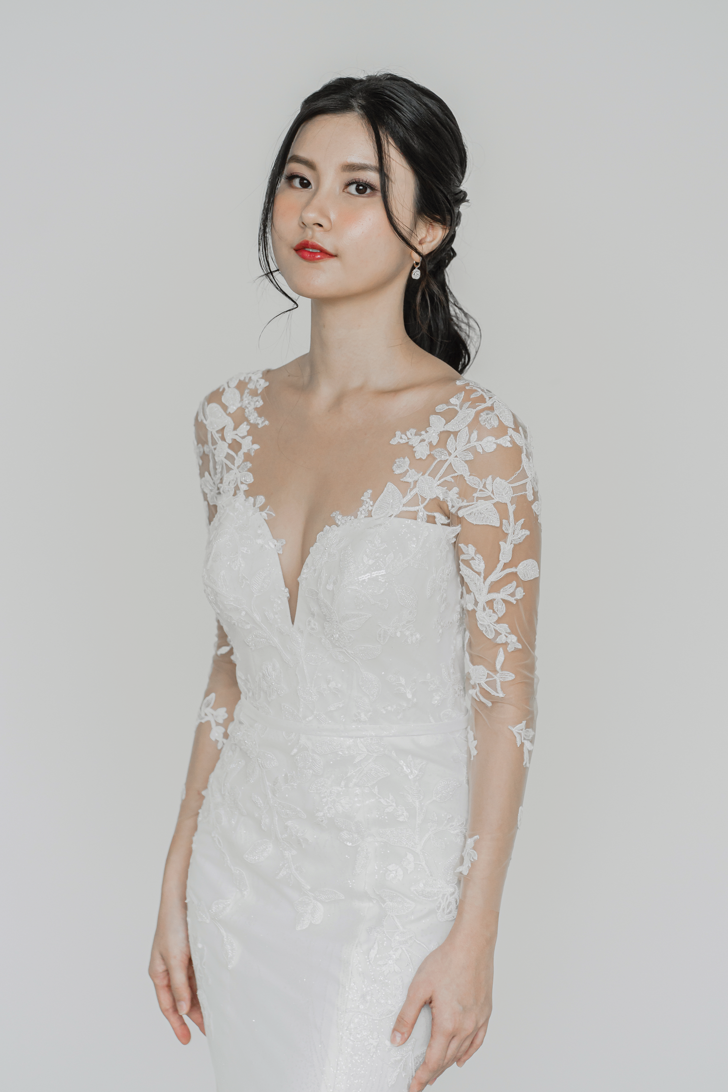 Stefani wedding dress front view with illusion long sleeves and a plunging neckline