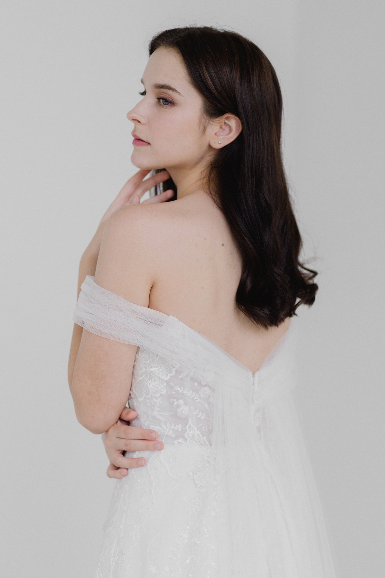 Close-up of Tracy wedding gown with floral lace and tulle off-shoulder sleeves