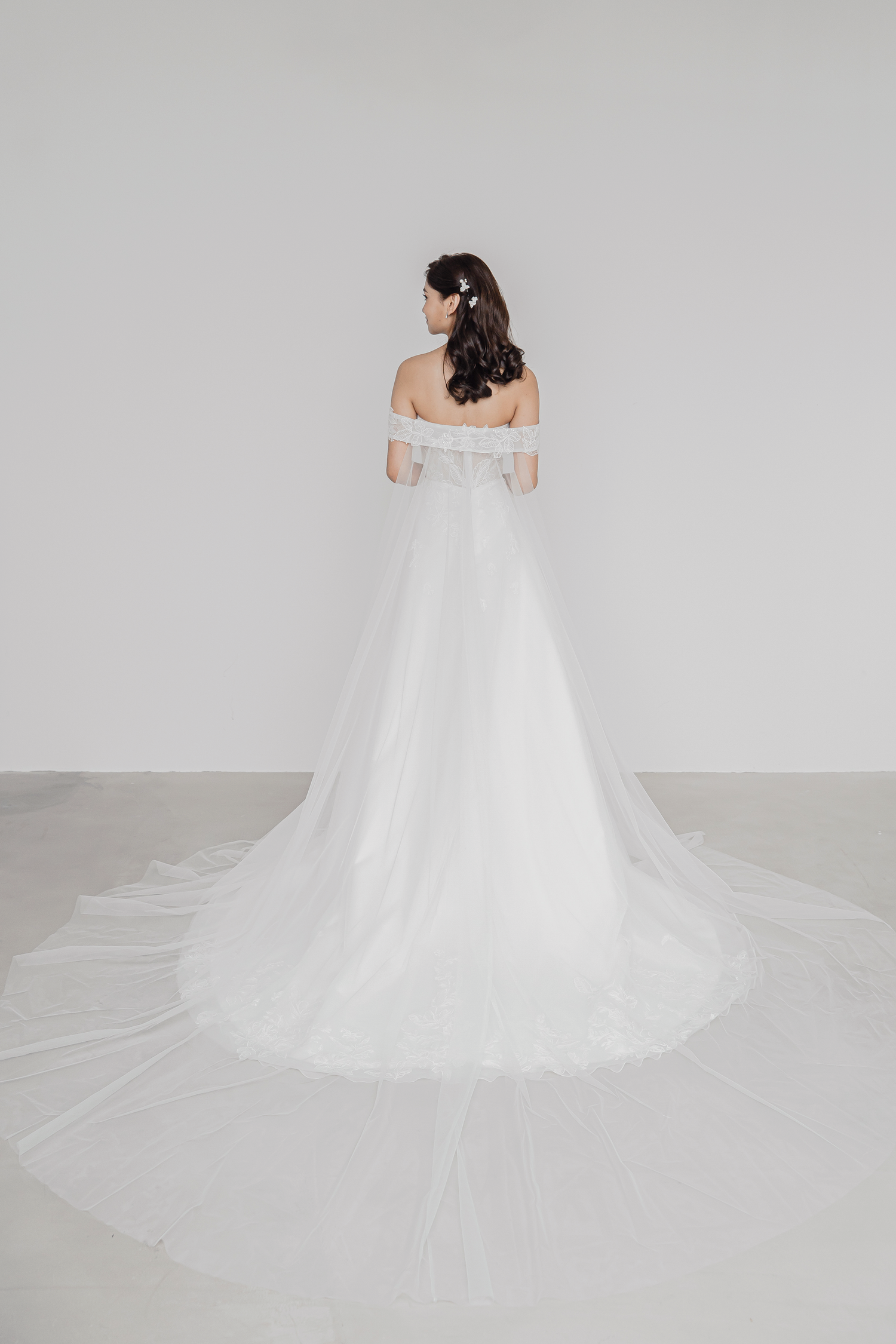 Trudy wedding dress styled with a detachable off-shoulder cape train
