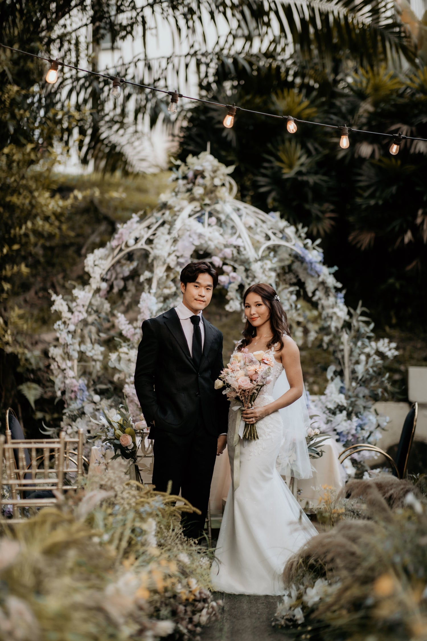 WeddingCrafters real bride wearing a fitted white wedding gown at her outdoor ceremony
