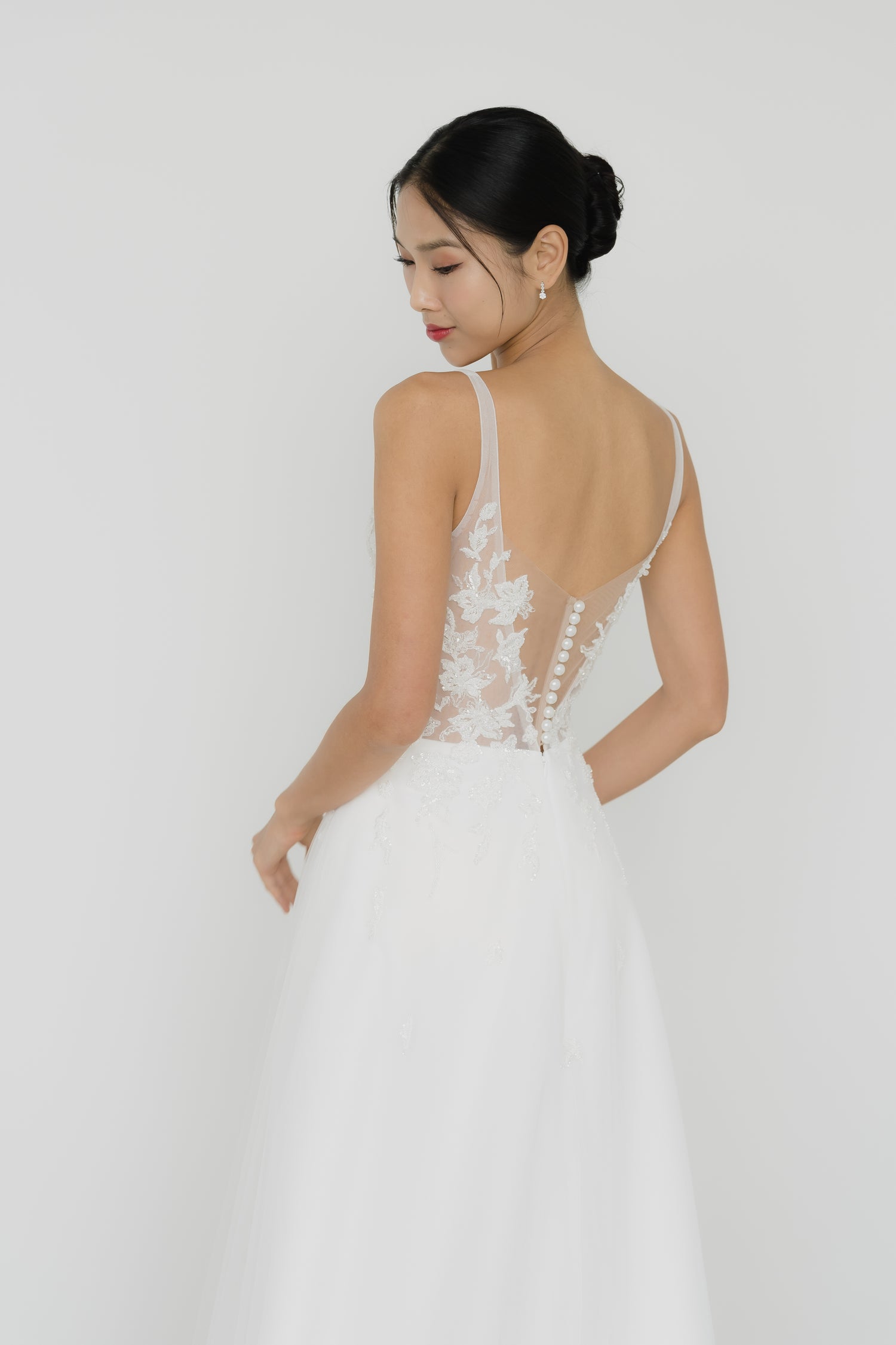 Close-up of Willow wedding gown highlighting the elegant pearl buttons on the back