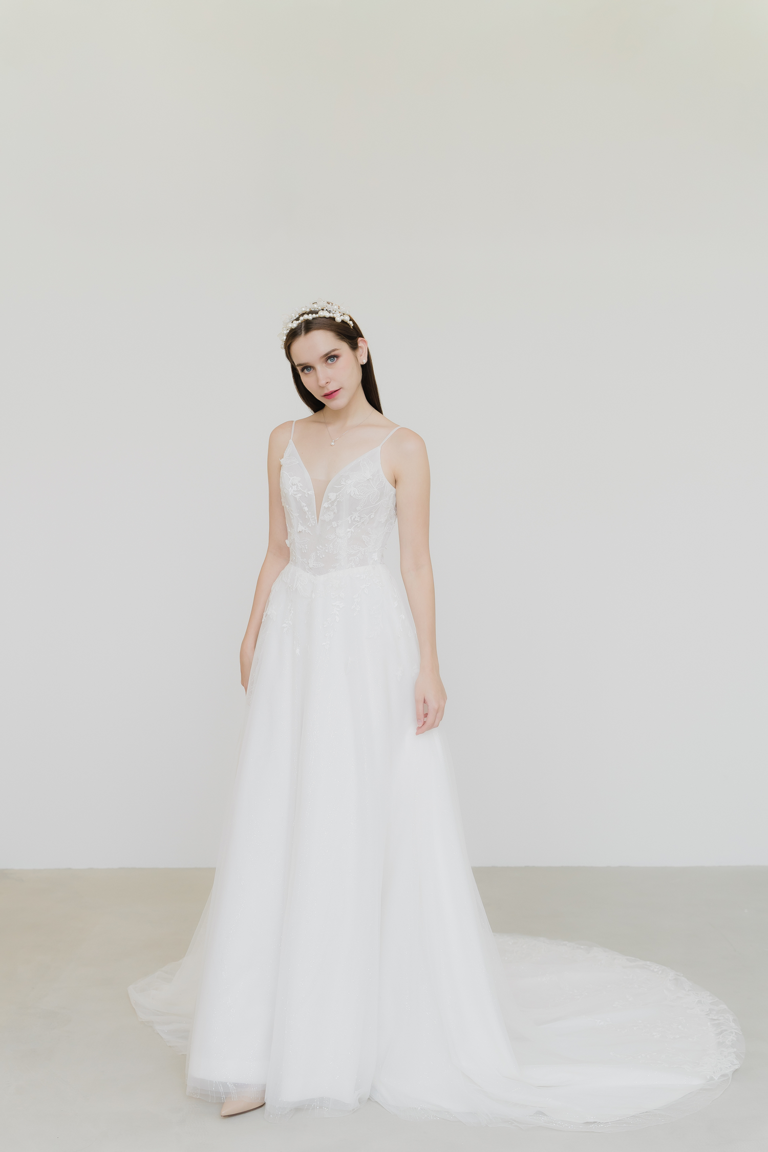 Abigail wedding dress front view with delicate spaghetti straps and a flattering basque waist
