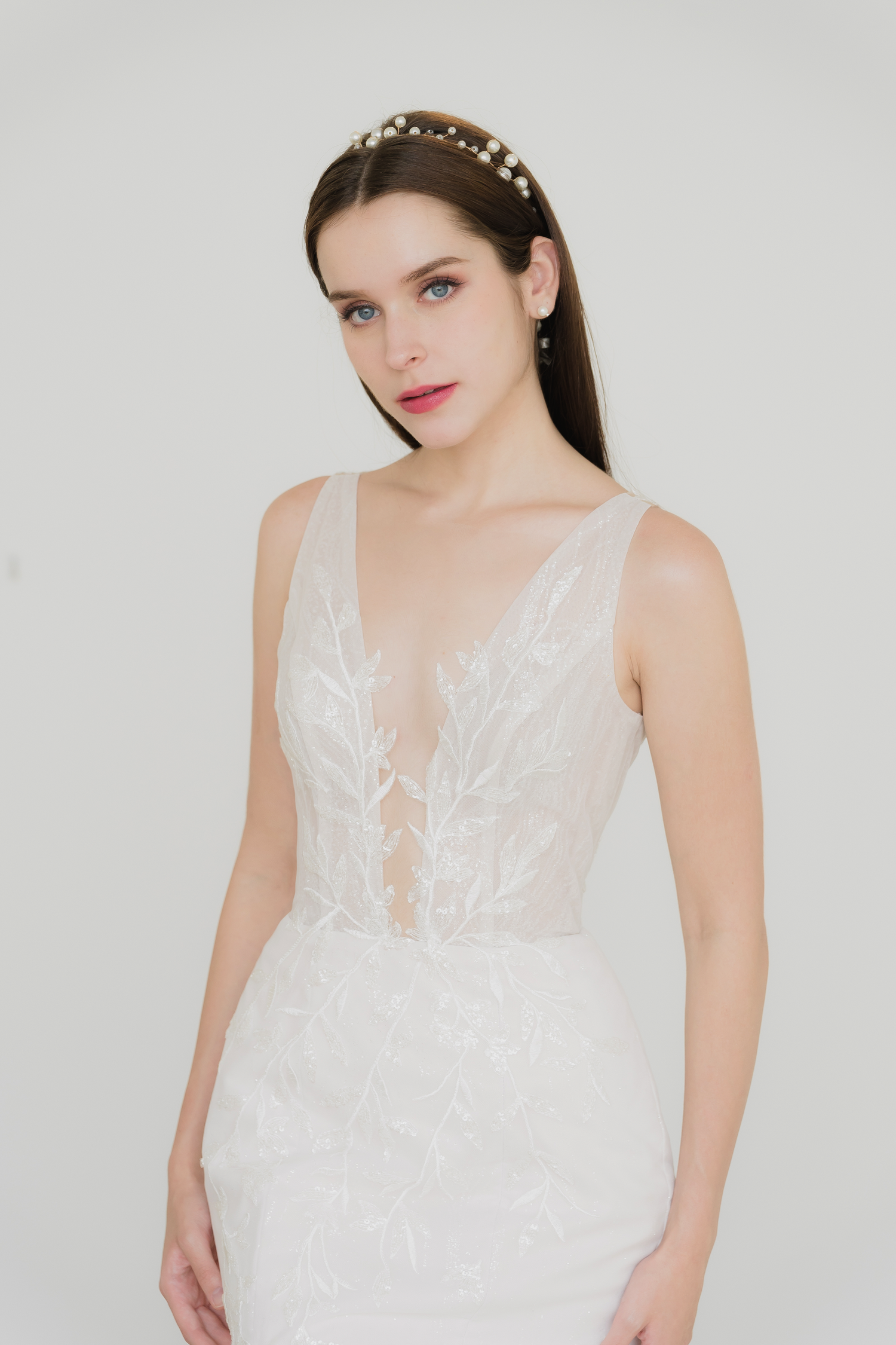 Alana bridal gown front view with a plunging illusion neckline and hourglass silhouette