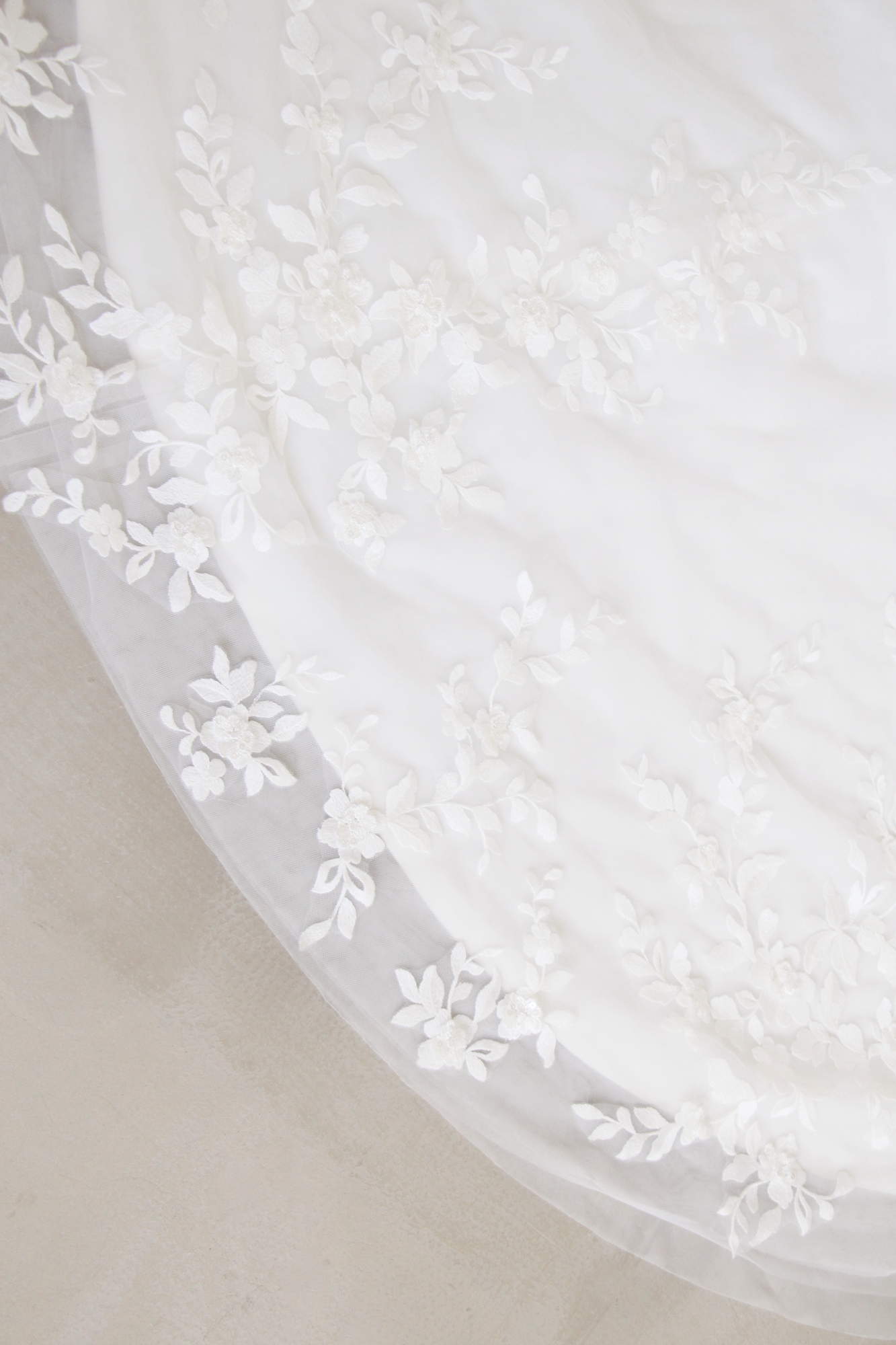 Close-up of Alsa wedding dress with romantic floral lace detailing