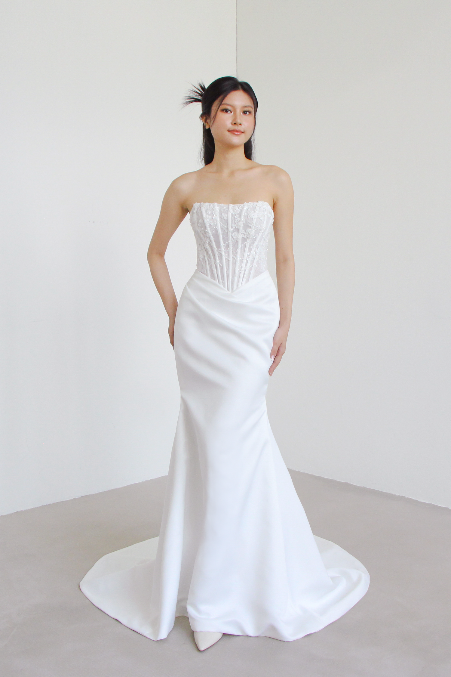 Amara bridal gown featuring a lace corset bodice and sleek satin relaxed mermaid silhouette