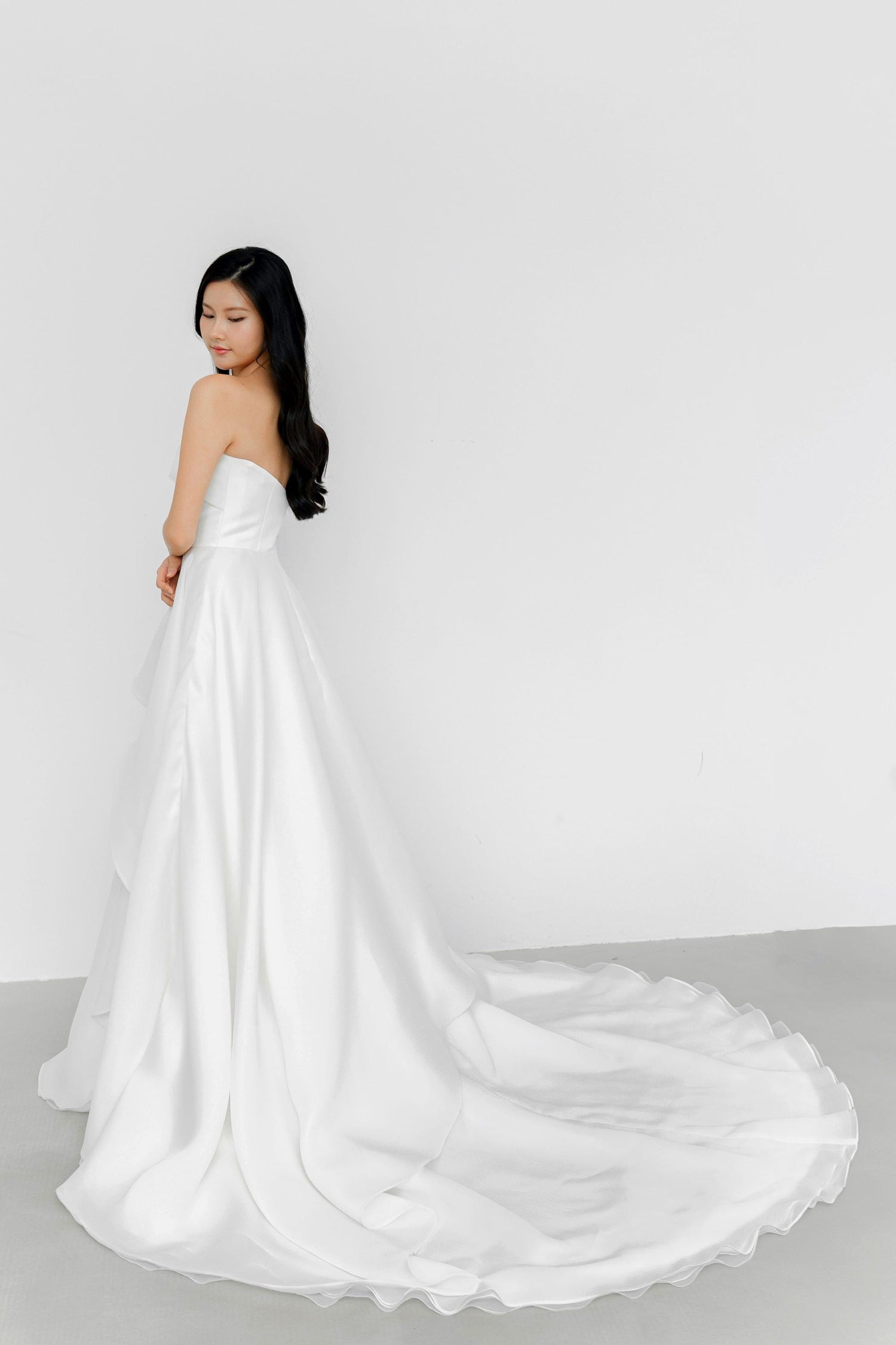 Arabelle wedding gown side view showcasing the flowing organza layers