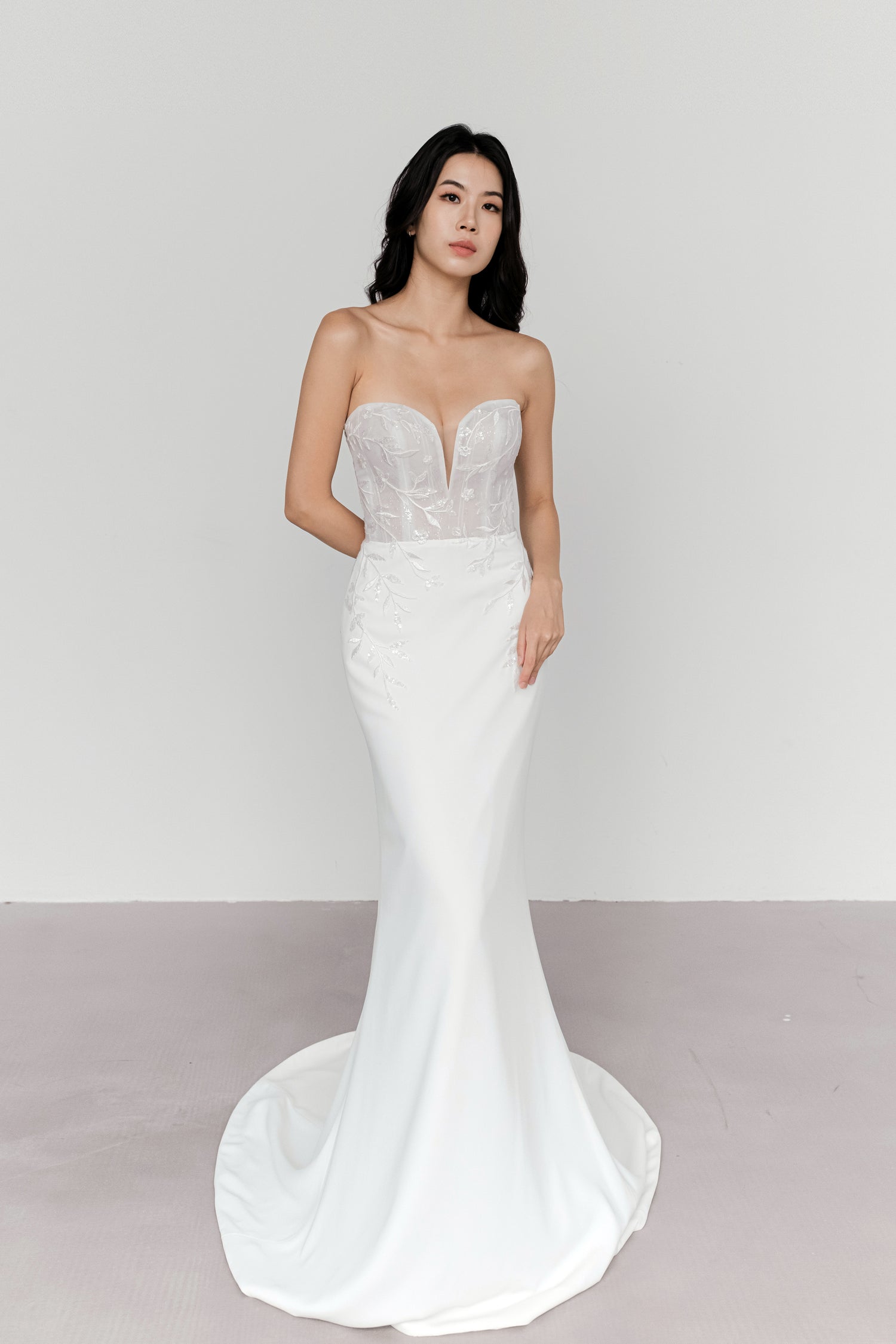Aria bridal gown featuring hand-embroidered botanical lace and a fitted mermaid silhouette