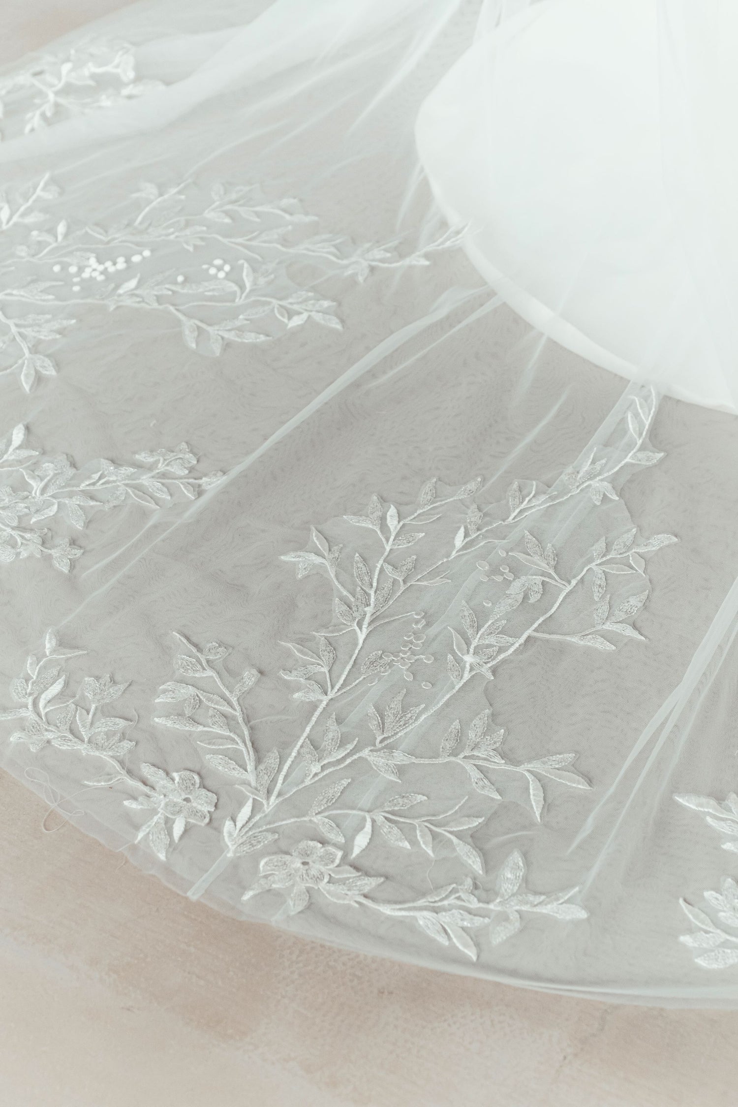 Close-up of Aria wedding gown highlighting the intricate botanical lace embroidery