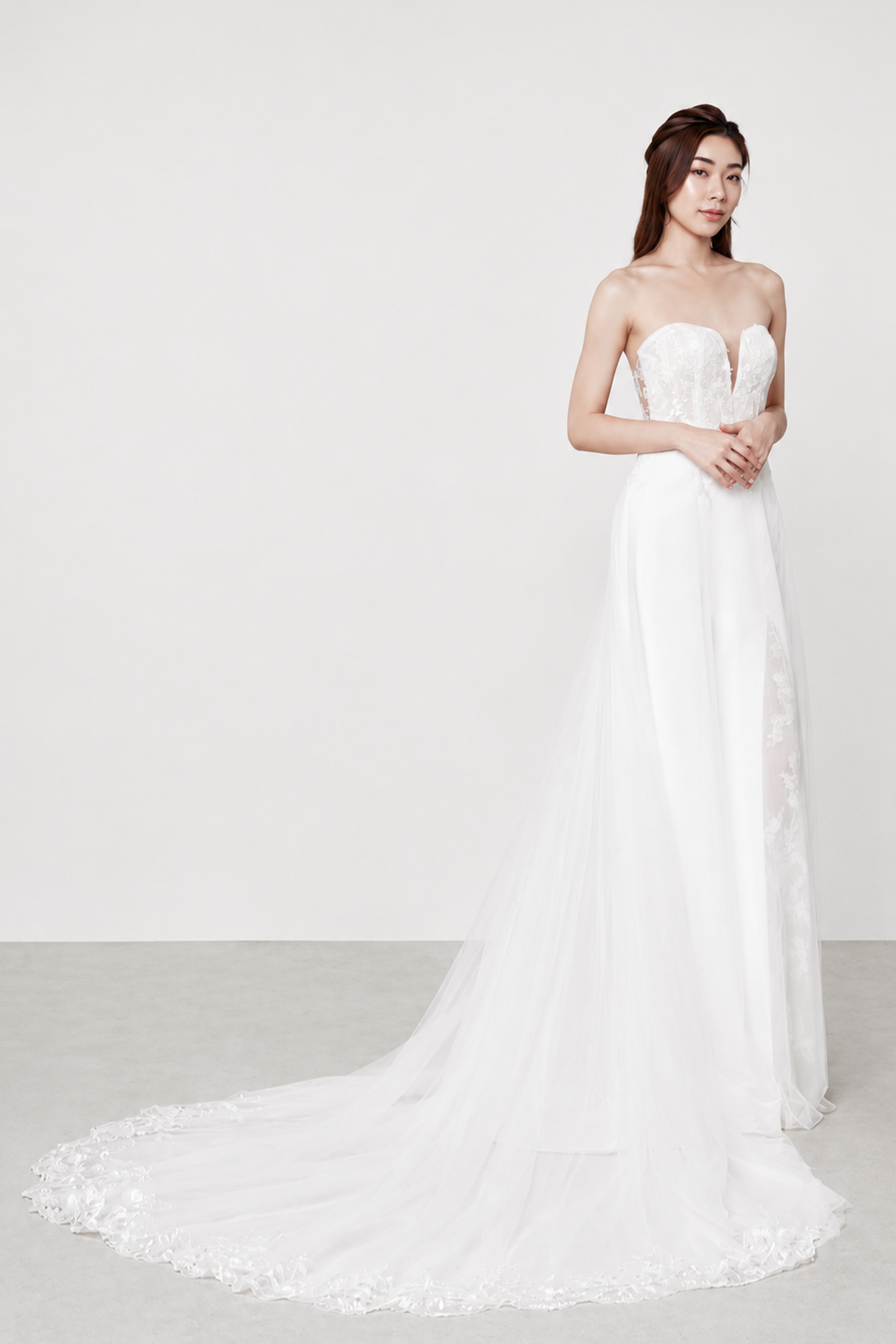 Aries is a versatile gown featuring a sweetheart neckline, a delicate lace bodice with a sleek crepe skirt, and a peekaboo lace slit. Complete the look with the detachable soft A-line tulle overskirt for a romantic second style.