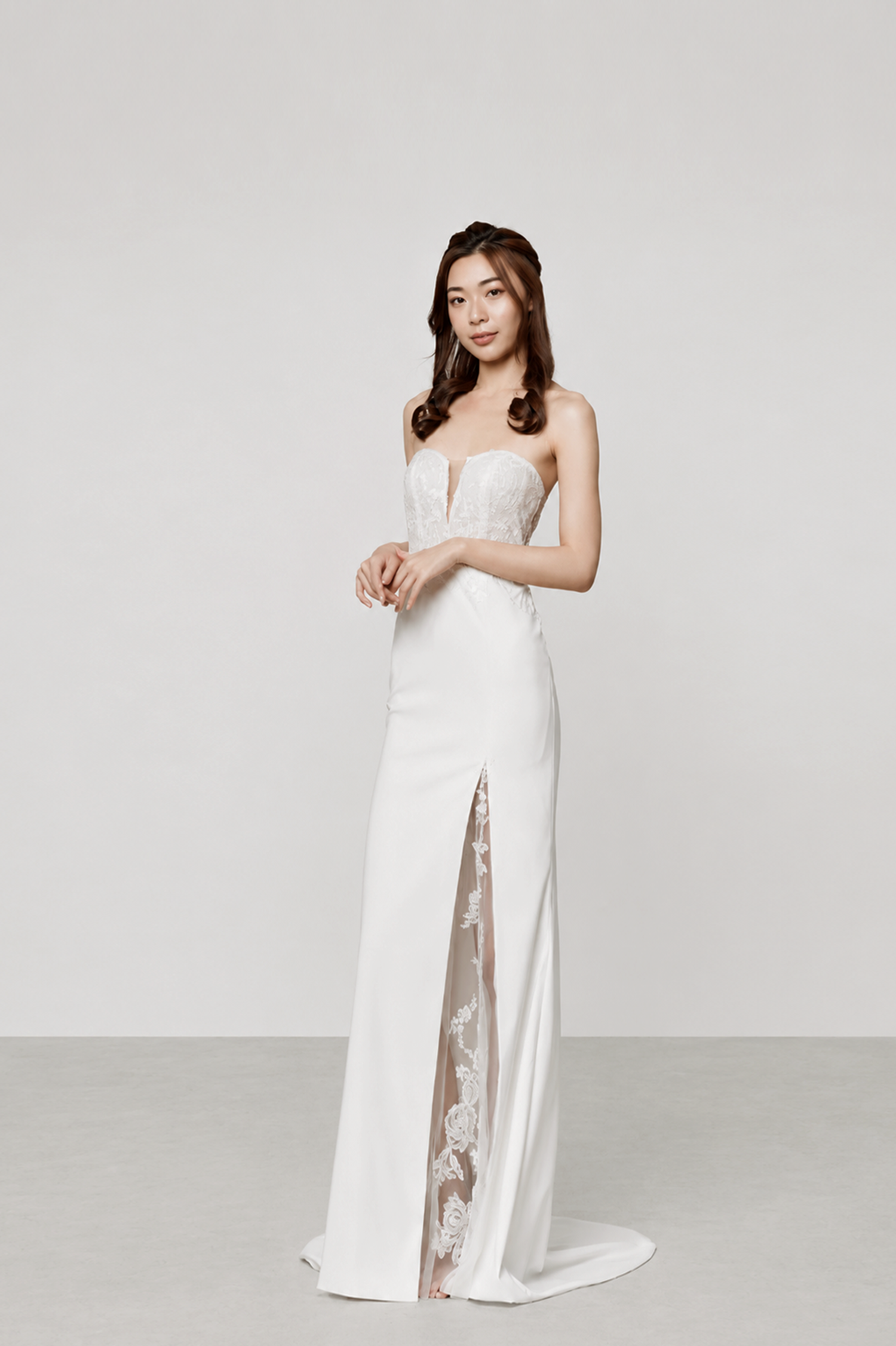 Aries bridal gown side view showcasing the elegant fitted silhouette and lace-lined slit