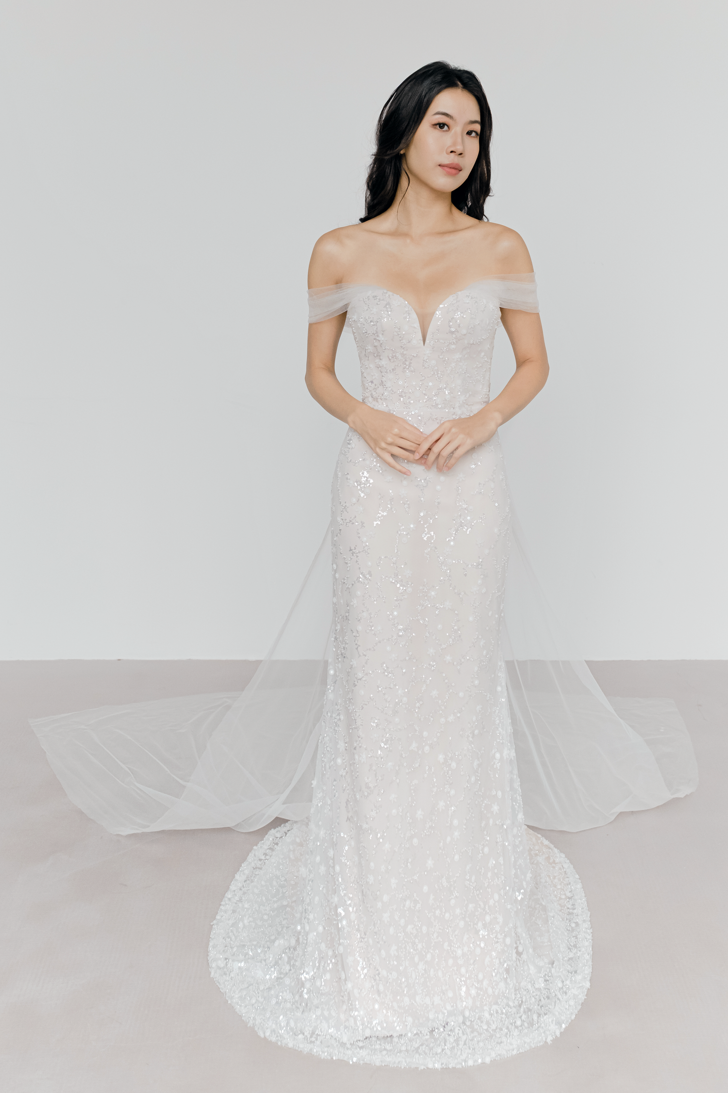 Aurelia bridal gown front view with intricate layered beadwork on a nude-toned base