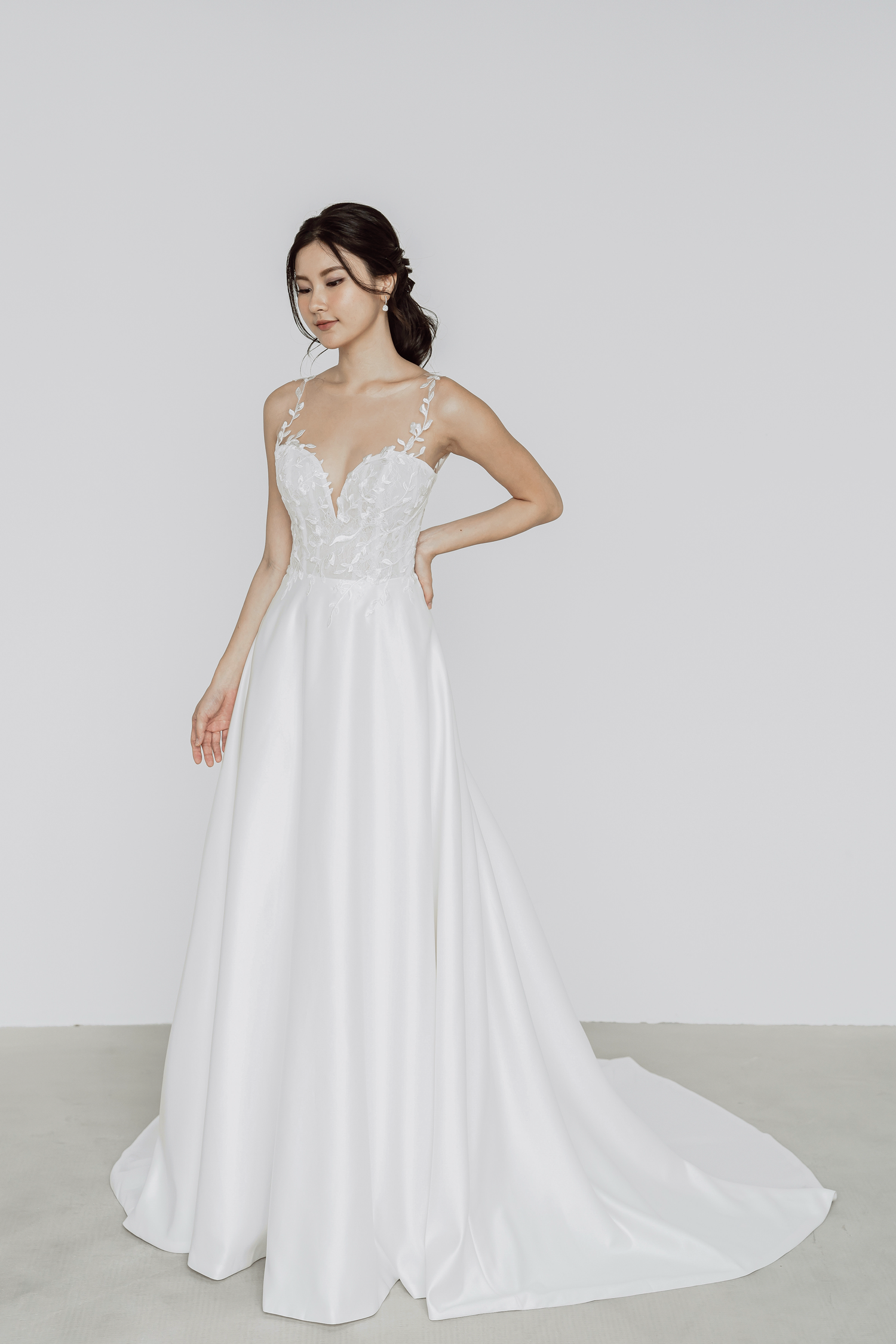 Bella bridal gown side view with a flowing satin skirt