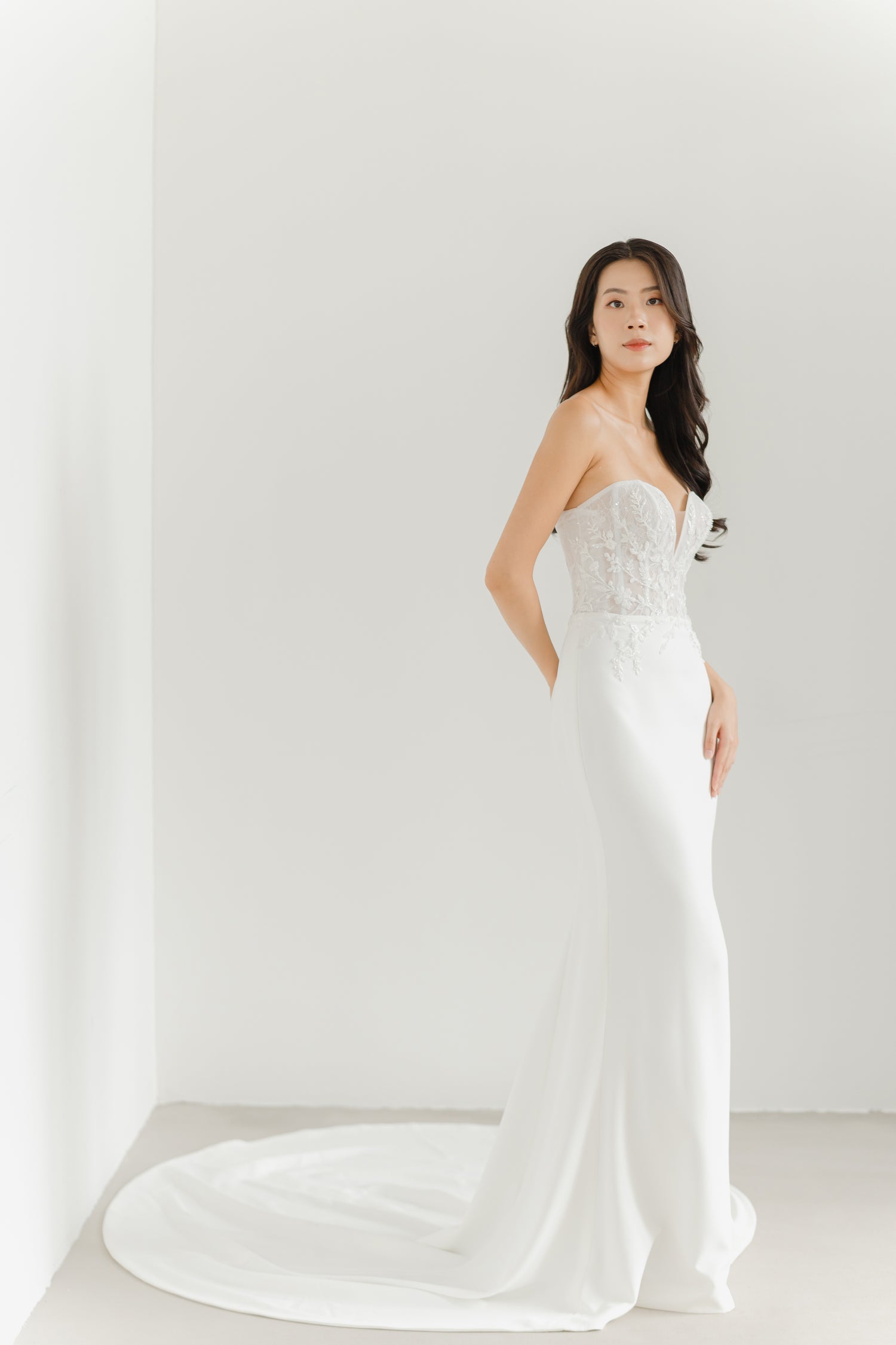 Benetta bridal gown side view showcasing the sleek crepe mermaid silhouette