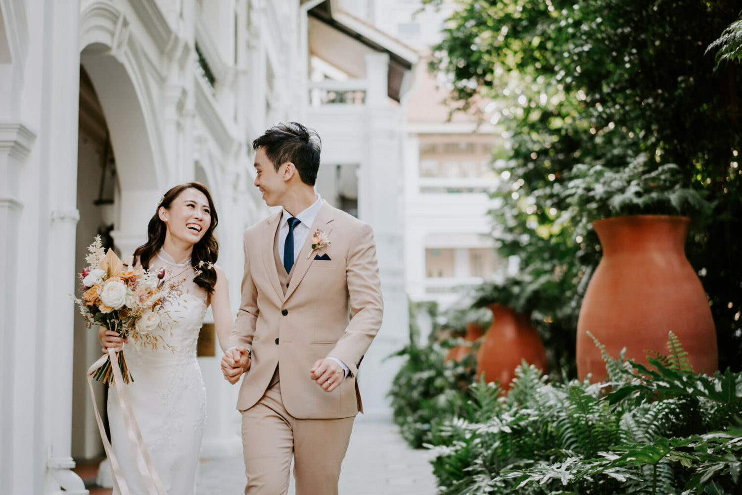 Bride and groom during their wedding day in Singapore, featuring a custom WeddingCrafters bridal gown.