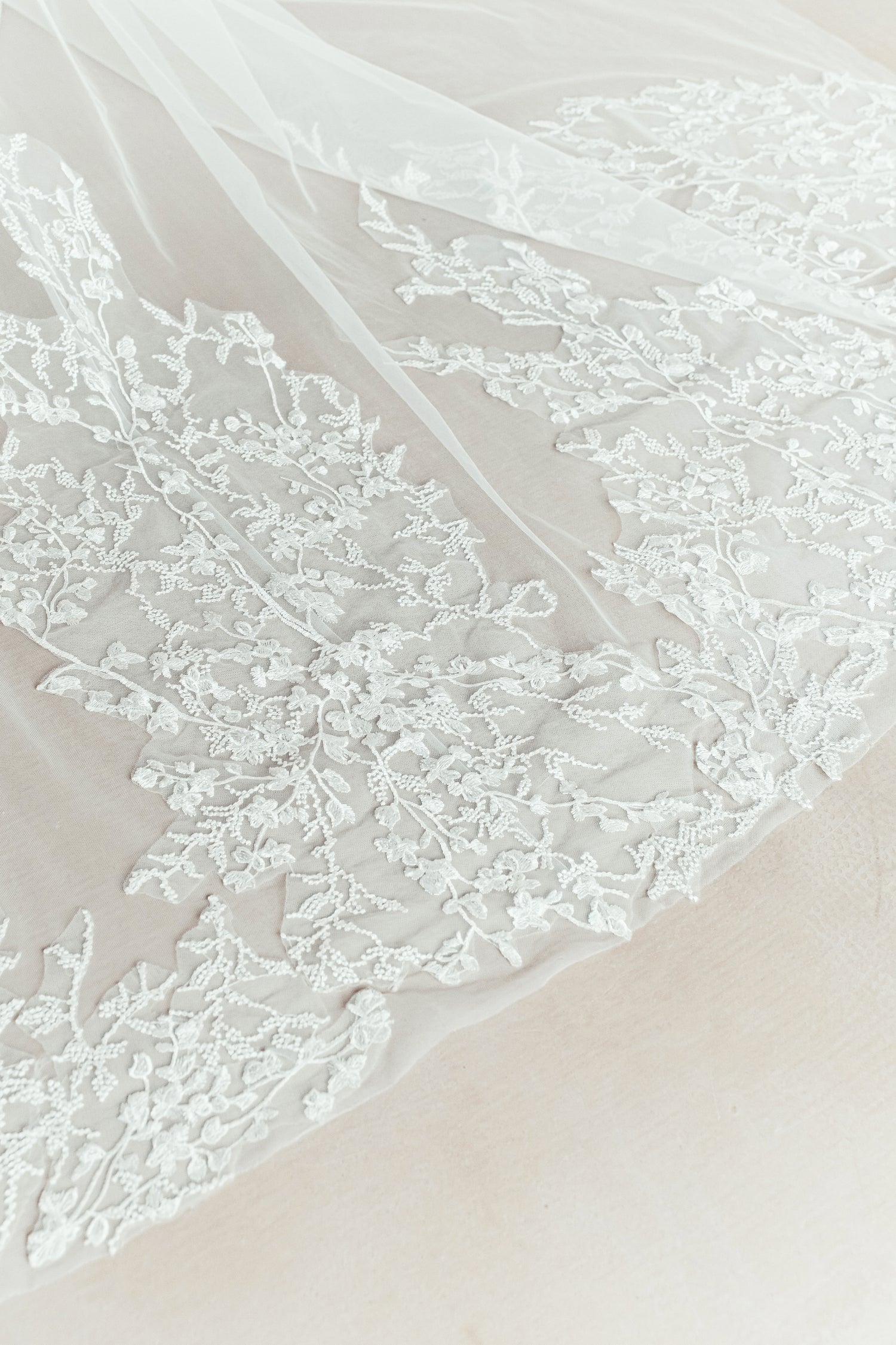 Close-up of Beverly bridal gown showcasing the soft layers of the detachable tulle train