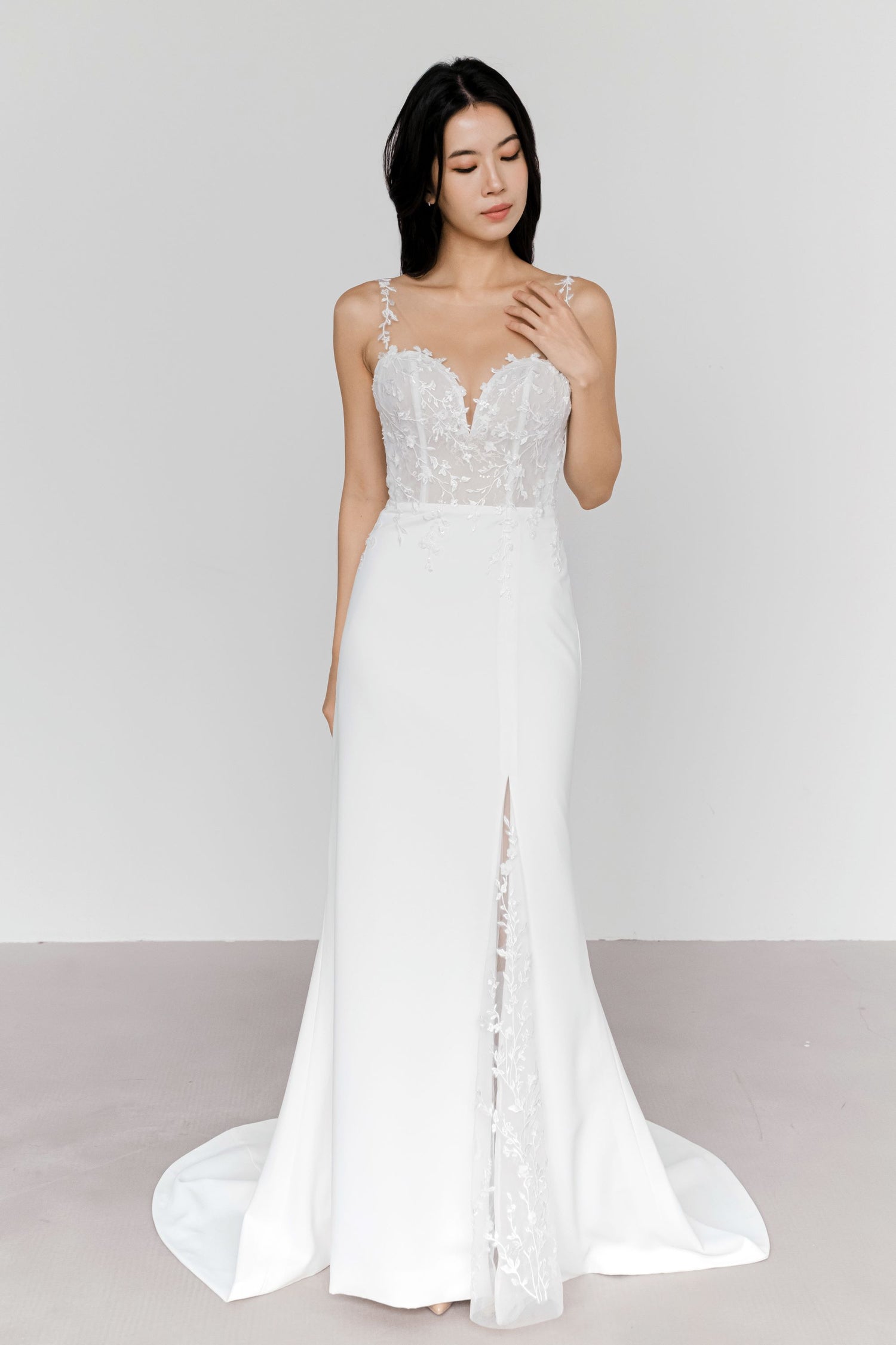 Beverly wedding gown side view showcasing the elegant fitted silhouette and lace-lined slit