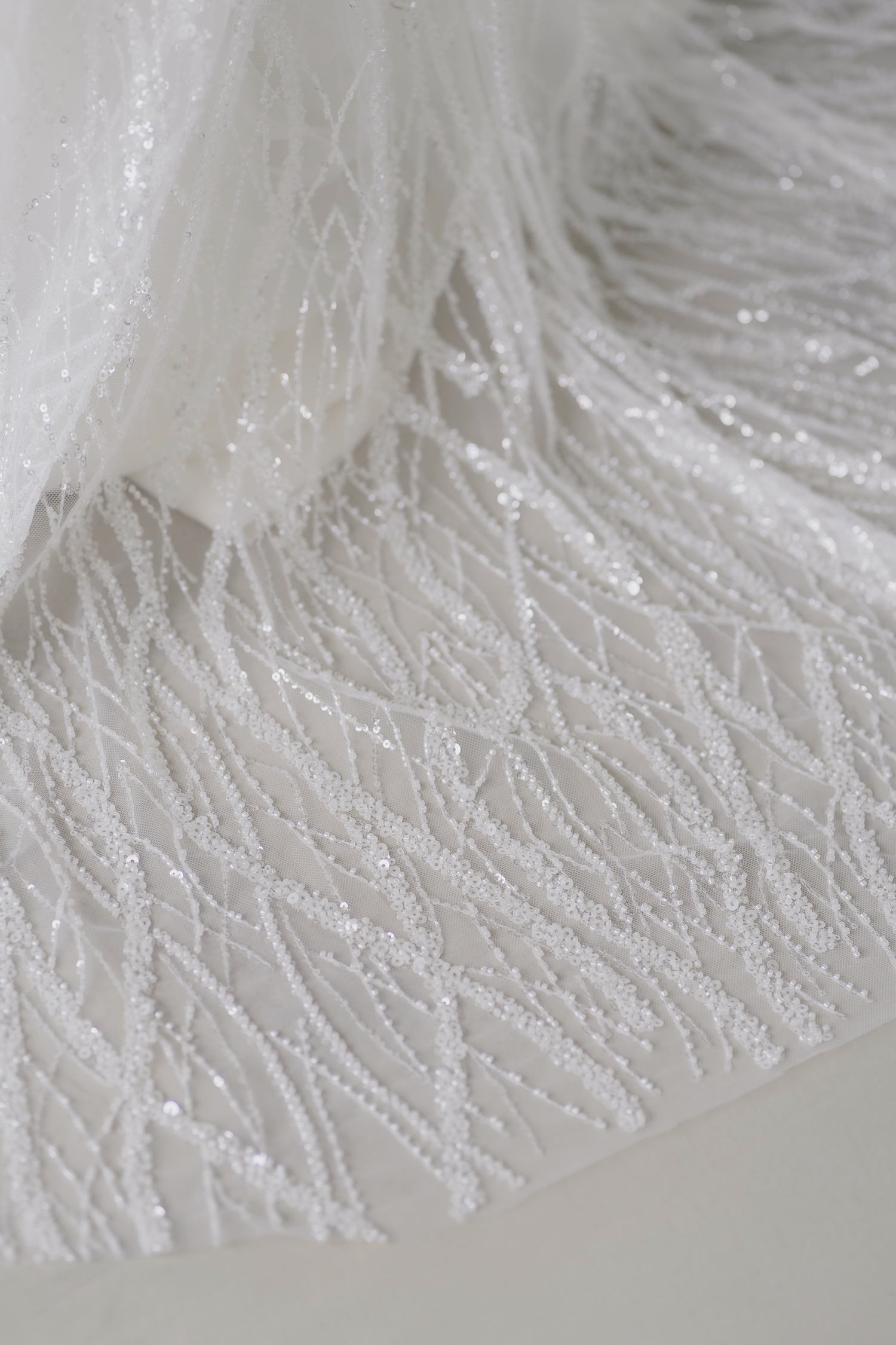 Close-up of Blake bridal gown with intricate wavy beadwork