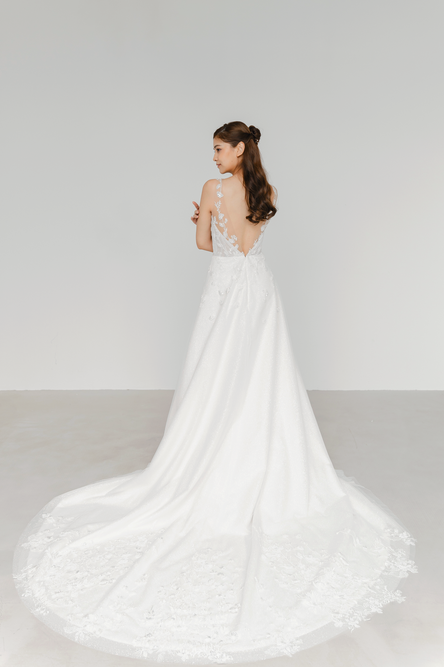 Calsida bridal gown back view with a flowing glitter tulle skirt