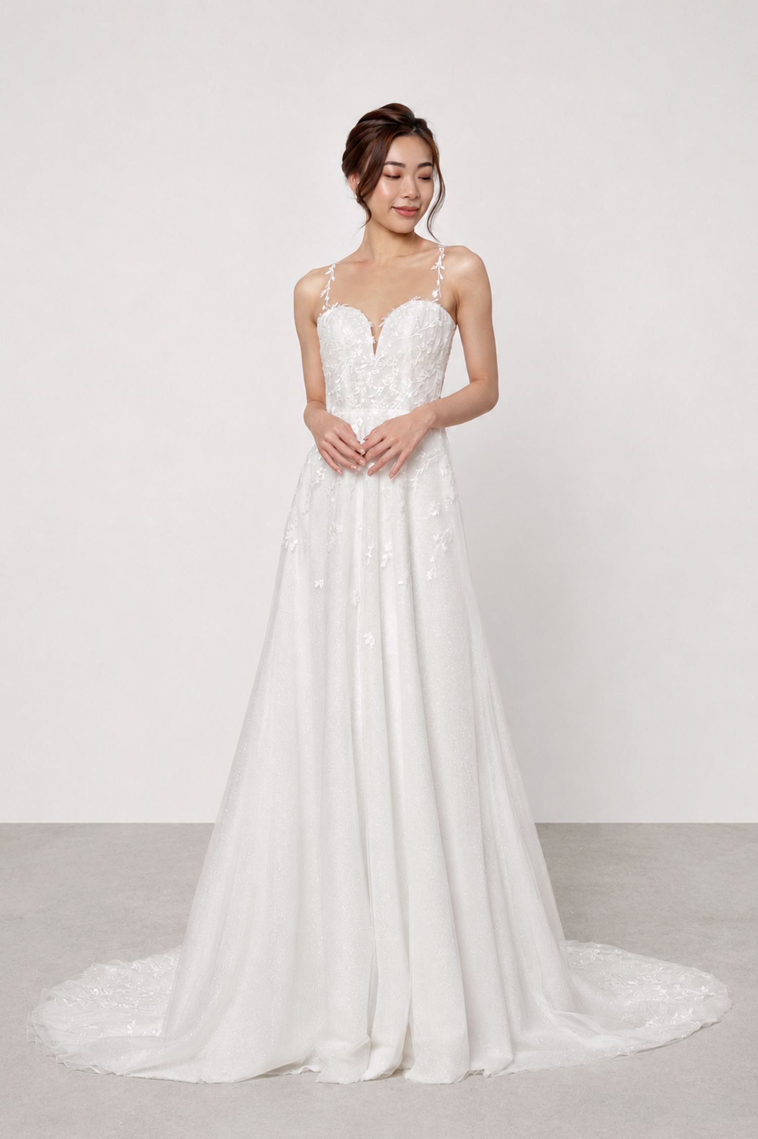 Carina bridal gown front view with an illusion neckline and delicate lace straps